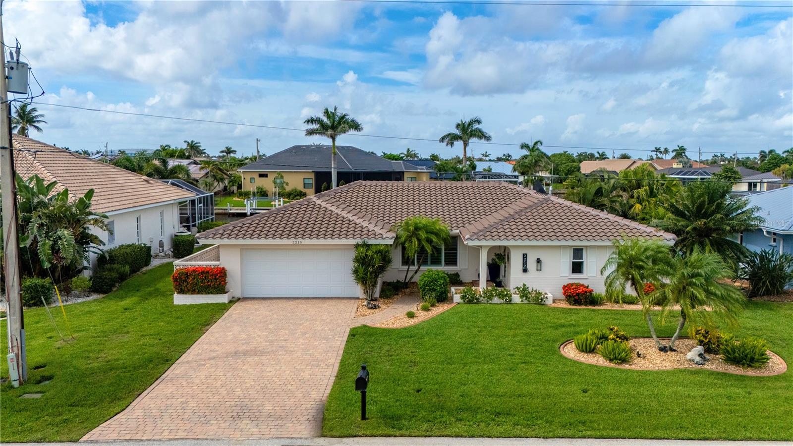 Immaculate design, effortless luxury, and Charlotte Harbor access come together in this NEWLY UPDATED Punta Gorda Isles waterfront retreat. From your private 32-foot dock with a 10,000 lb lift, you're just 15 minutes from open water-whether you're chasing the sunrise or heading out for waterfront dining. At home, the lifestyle continues with canal views, a saltwater heated pool, and refined outdoor living spaces designed for both relaxation and entertaining. Inside, the open floor plan is light, bright, and beautifully reimagined by Wetherington Restoration. The living room opens wide with triple sliders, leading to the pavered pool area and waterfront. An updated kitchen with granite counters and 2023 stainless steel appliances flows into a cozy dinette and family room, where large impact picture windows bring the water views in. Stylish neutral tile flooring and updated fixtures run throughout the home. A 9 ft granite bar on the covered lanai creates the perfect pass-through for sunset cocktails or weekend gatherings. The L-shaped pool with screened lanai seamlessly incorporates the new spa into its design, providing both generous swim space and a relaxing retreat in one cohesive layout. The owner's suite features private lanai access, a spa-inspired bath with dual sinks and walk-in tiled shower, and a large closet. The guest wing offers a spacious second bedroom and a completely updated bath with walk-in shower. Plus, a newly added laundry room adds an extra 181 heated sqft. Every detail-from the elegant lighting to the hurricane-rated windows and reinforced garage door-has been curated with comfort and style in mind. With a brand new 2024 roof (under warranty), mature landscaping, outdoor lanai space, new baby pool barrier fence, and a pavered driveway that elevates curb appeal, this home is move-in ready and designed for those who value both quality and the coastal lifestyle. Located in the highly desired Punta Gorda Isles a deed restricted, waterfront community this home has easy access to downtown restaurants, entertainment, Fisherman's Village, and the Punta Gorda airport. This one is a MUST-SEE!!