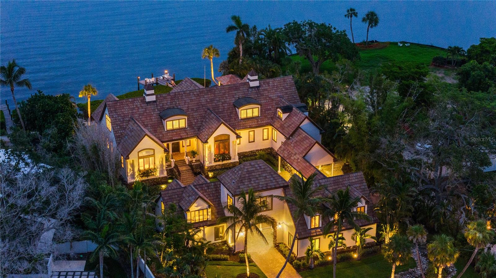 Experience the epitome of exclusivity with unheard of waterfront views, unmatched privacy, and breathtaking, expensive vistas from your own private island retreat. Tucked away on a private island in Siesta Key’s South Cocoanut Bayou, this Tuscan-inspired estate feels like it’s been plucked from the pages of a storybook. The estate at 4315 Mangrove Place features a Tuscan-inspired central courtyard with over 4000 sq ft designed as the heart of the home. It is a grand, open-air courtyard enclosed by both the main residence and the guest villa, connected via an elegant, covered breezeway.
The main residence offers soaring ceilings, intricate millwork, and expansive living spaces ideal for entertaining or quiet coastal living. A gourmet chef’s kitchen, formal dining room, library, owner ensuite located on the main level with his & hers walking closets and bathrooms, and custom home theater create a balanced blend of function and indulgence.
Connected by a covered breezeway, the guest villa features its own living quarters, private elevator, one bedroom, full bathroom, living room and full kitchen—perfect for multigenerational living or extended guests.
With six bedrooms, nine baths, a three-car garage, and an ambiance that feels like a timeless escape, this estate is more than a home—it's a legacy, a retreat, a living Castle fairytale.
Outdoors, a resort-style pool and spa, and lush tropical landscaping create a serene oasis, while a private deep-water dock provides direct access to the Intracoastal and Gulf with no fixed bridges. Eligible to membership to private beach.