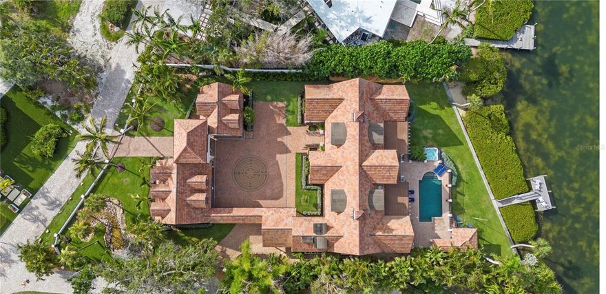 Private Island, Gated Home, Private access to deeded beach!

Experience the epitome of exclusivity with unheard of waterfront views, unmatched privacy, and breathtaking, expansive vistas from your own private island retreat. Tucked away on a private island in Siesta Key’s South Cocoanut Bayou, this Tuscan-inspired estate feels like it’s been plucked from the pages of a storybook.  The estate at 4315 Mangrove Place features a Tuscan-inspired central courtyard with over 4000 sq ft designed as the heart of the home. It is a grand, open-air courtyard enclosed by both the main residence and the guest villa, connected via an elegant, covered breezeway.
The main residence offers soaring ceilings, intricate millwork, and expansive living spaces ideal for entertaining or quiet coastal living. A gourmet chef’s kitchen, formal dining room, library, owner ensuite located on the main level with his & hers walking closets and bathrooms, and custom home theater create a balanced blend of function and indulgence, Elevator in main residence & private elevator in guest house.
Connected by a covered breezeway, the guest villa features its own living quarters, private elevator, one bedroom, full bathroom, living room and full kitchen—perfect for multigenerational living or extended guests. 
With six bedrooms, nine baths, a three-car garage, and an ambiance that feels like a timeless escape, this estate is more than a home—it's a legacy, a retreat, a living Castle fairytale.
Outdoors, a resort-style pool and spa, and lush tropical landscaping create a serene oasis, while a private deep-water dock provides direct access to the Intracoastal and Gulf with no fixed bridges. Eligible to membership to private beach.