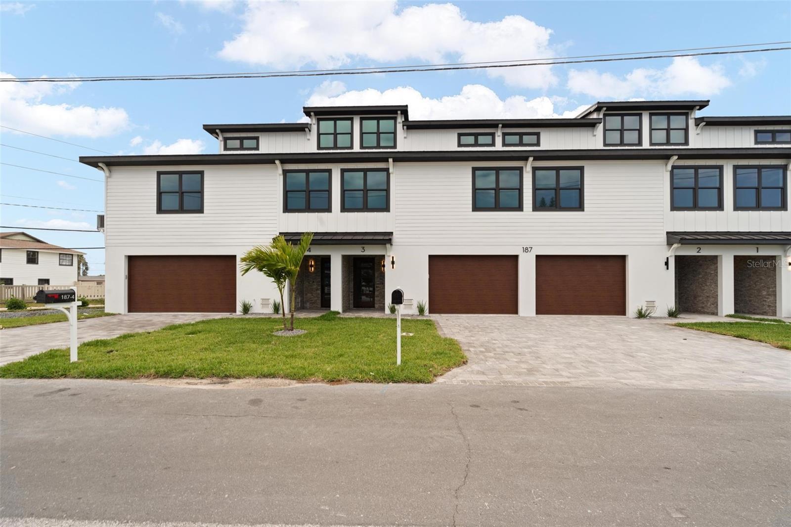 New Construction Coastal Luxury Townhome at Madeira Beach Walk Condos in the Heart of Madeira Beach ! Never Lived In & Perfectly Move in Ready ! Just Steps to the Beach & the Intracoastal ! Easy to Maintain LVP Floor Throughout, Along with Neutral Paint, & Gorgeous Coastal Selections. You'll Love the Open Floor Plan on the Second Level ! The Kitchen with Massive Eat In Island & Stainless Appliances Shares Space with the Great Room & Dining Area Highlighted by Trey Ceiling & Loads of Natural Light. On the Second Level You'll Also Find Two Bedrooms, a Shared Full Bath, & the Laundry Area Accompanied by Plenty of Hanging/Storage Space. Upstairs Is the Primary Suite Boasting Your Own Private Patio Access with Water Views & a Seating Area in Addition to the Master Bath & Huge Master Closet with Custom Organizing System. The Garage Level Boasts Room for Up to 4 Vehicles & Plenty of Storage. Townhome Comes with Elevator Shaft, Making it Easy for a Future Transition to No Stairs. Enjoy Entertaining on Multiple Outdoor Levels with Intracoastal Views. Just Seconds to Dining, Shopping, & Popular John's Pass. COA Covers Master Insurance, Water/Sewer/Trash, Irrigation, & Exterior Maintenance. Pool, Fence, & Patio Additions, as Well as Rentals are Permissible. Seller Willing to Consider Short Term Seller Financing at Market Rates/Terms. Will Also Consider Short Term Rentals for Slight Premium - Please Inquire. Not Many Brand New Construction Opportunities in Madeira Beach. Live the Dream in One of Florida's Most Highly Desired Locations. Don't Wait on Paradise !