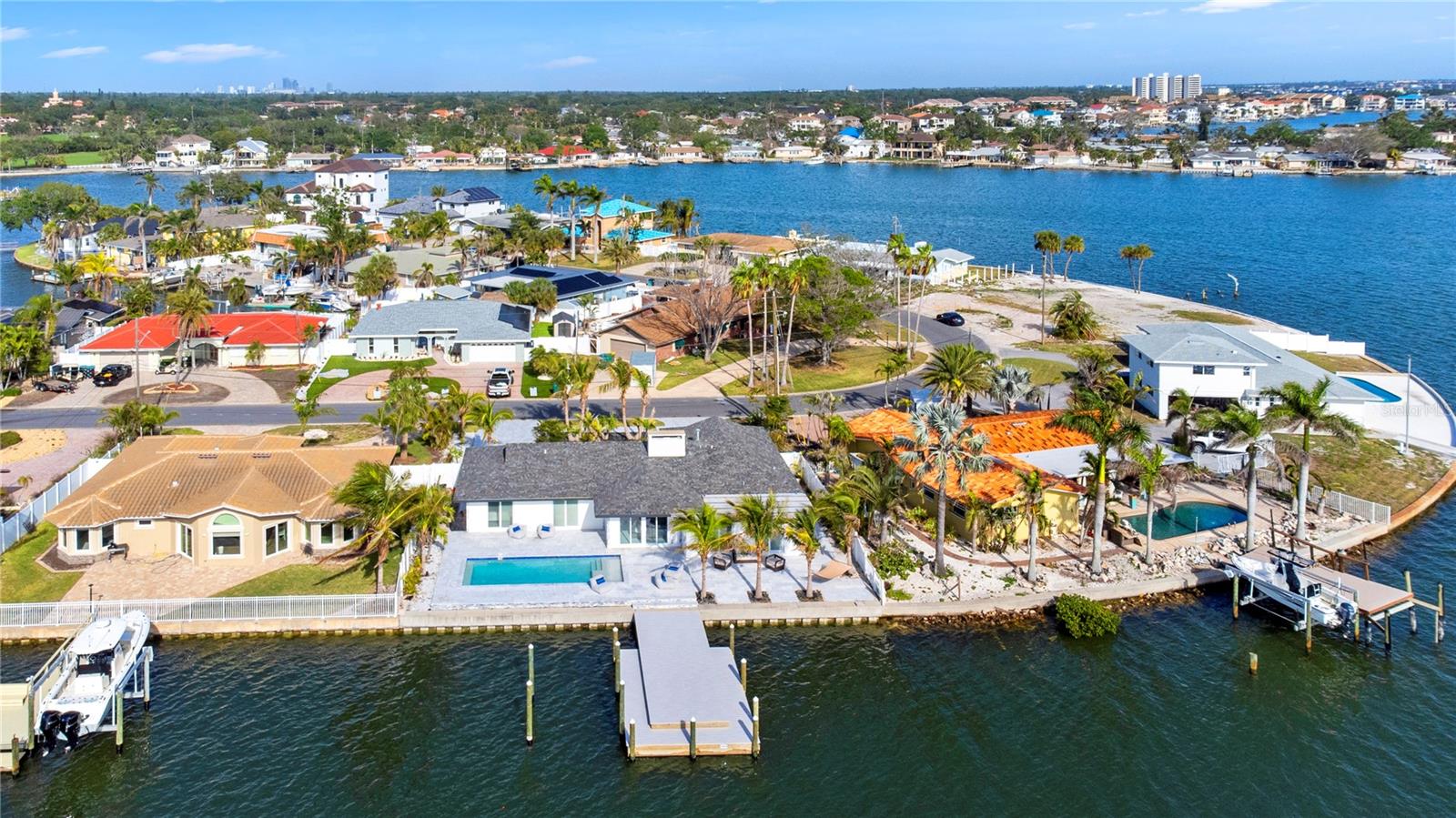 Experience true waterfront living and unforgettable sunsets from your own backyard in the highly sought-after Pasadena Golf Club Estates, located in unincorporated Pinellas County. This fully renovated coastal retreat is a boater’s dream, offering deep water docking on the Intracoastal Waterway of Boca Ciega Bay, with easy access to Tampa Bay and the Gulf of America! The 2019 wide-depth seawall supports a brand new TREX dock, featuring a 12x36 main dock and a 4x24 lower dock, ideal for all your water toys and marine adventures. Cool off in the brand new saltwater pool, set in a luxurious imported marble decking and surrounded by lush coconut and Tahitian palms—part of a landscape investment of over $50,000. Inside, you’ll find over-the-top upgrades and thoughtful design touches throughout, including: Custom-designed kitchen with over 30 feet of counter space, solid wood cabinetry, brushed gold hardware, 36” porcelain farmhouse sink, GE Monogram appliances including a 48” gas range and 48” refrigerator, and a custom wet bar with an oversized wine cooler (holds 90+ bottles) LVP flooring in bedrooms, mosaic tile, and all new LED lighting & fixtures Spacious Living Room with a wood-burning fireplace Primary Bedroom with water views, three closets, and an en-suite bath Indoor Laundry Room with matching custom cabinetry Tankless water heater, 2023 A/C, epoxy garage floor, and marble paver circular driveway This home offers three bedrooms, two bathrooms, and a layout perfect for both relaxing and entertaining. Enjoy 86 ft x 100 ft of land (.197 acre) and .203 acre of deeded water rights. All of this is just 10 minutes from St. Pete Beach and the Gulfport Arts District, and only 15 minutes to vibrant Downtown St. Pete, filled with award-winning dining, shopping, and entertainment. Don't miss this rare opportunity to own deep water access and breathtaking waterfront views in one of the area’s most desirable neighborhoods. Schedule your private showing today!