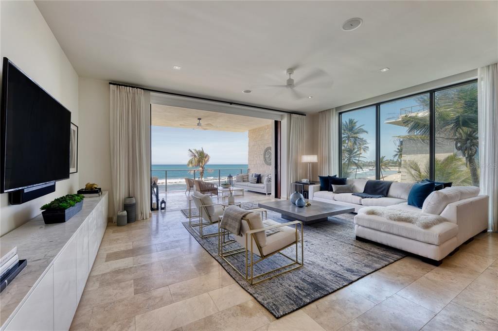A true to form Contemporary Coastal design, residence 3831 in the newest construction at West Beach, elevates the luxurious backdrop of the Ritz-Carlton Reserve, Dorado Beach, to a completely unique experience. The primary suite with five-fixture custom standalone shower and soak tub, two additional en suite bedrooms, designer kitchen with exposure to a landscaped north-facing garden/beach/ocean, all offer extraordinary living and resting spaces with heightened volumes of natural light and style.
Custom color palette on all doors and cabinetry, with matching gold and black fixtures throughout and upgraded light fixtures and mirrors are unique to this West Beach home, in its totality. Setting the tone of ultimate relaxation in this coastal contemporary, donned with white custom marble or porcelain slab countertops on all cabinetry, throughout. Matching RH fans upgrade ties the interior entertaining with the exterior living.
From the porcelain farmhouse sink in the elegantly appointed kitchen to the curated light piece over dining designed by Lindsey Adelman, this design inspired West Beach home truly offers a one of a kind space, at this Caribbean beachfront locale.
The panoramic Northern view to the beachfront and the ocean are just as spectacular during the day as they are at sunset. With six spacious walk in closets and a hall linen closet, this unit boasts more than twice the closet space of all previous West Beach buildings.
This beautiful apartment comes with the highly sought after in West Beach, private fully climate controlled garage.