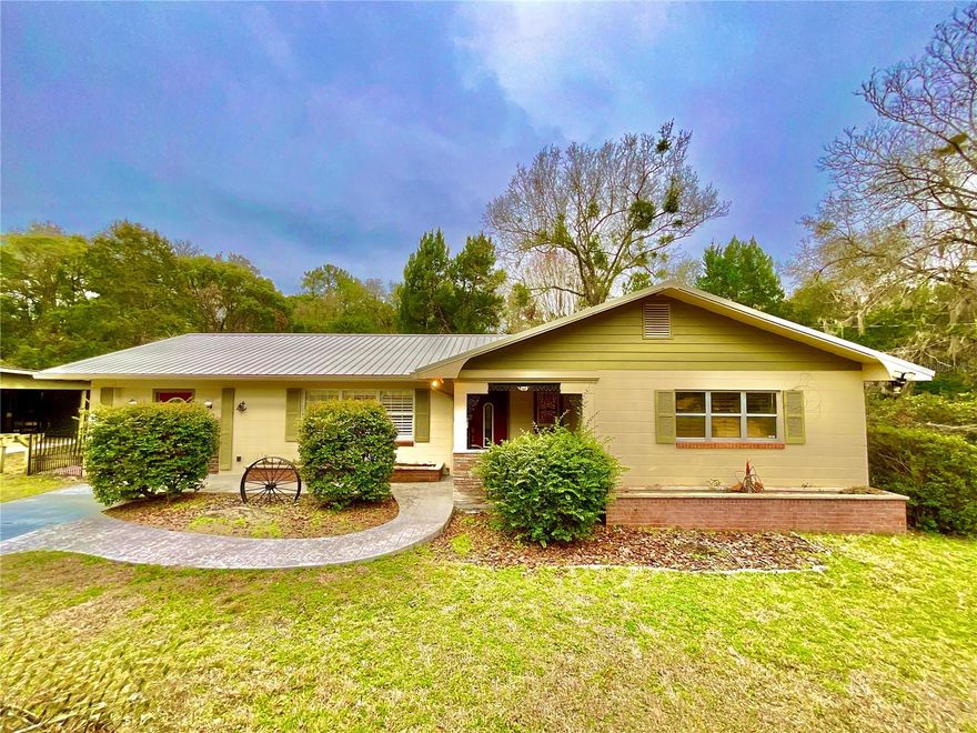 Look no further for your dream property. This beautiful and restored 3 BR 2 BA block home offering 1561 square feet of living space on 3.8 acres is waiting for you. SURVEY AVAILABLE. Enjoy complete privacy or generate immediate ROI by splitting the property. This classic home has a newly remodeled kitchen with beautiful wood cabinets, tile floor and backsplash, stainless steel appliances and stylish counter tops. The living room and all bedrooms have amazing original terrazzo flooring that has been refurbished and polished.18 X 12  Bonus room with separate entrance has many possibilities. The bathrooms are warm, retro and nostalgic. New roof ( 2024 permitted),electric water heater, window blinds, ceiling fans, and well pump. Enjoy family gatherings under the 40X18 covered porch. Fully fenced back yard for pets or build your swimming pool. Huge 28 X 40  pole barn with 3 parking spaces and an additional carport.27X12 storage shed. Have NO fear of power outages as this home has a Generac whole home generator. This awesome property is just 15 minutes from Gainesville and 5 minutes from Melrose and  Lake Santa Fe for boating, fishing and swimming.