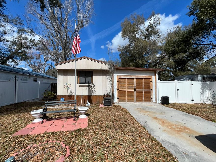 Affordable, adorable, and absolutely comfortable — this quaint and cute home is packed with updates and perfectly placed right in town! Step inside and you’ll love the warm, cabin-like feel that makes this home both cozy and inviting. The beautifully updated kitchen shines with modern finishes.  Beyond the kitchen is pantry with shelving that is sure to come in handy.  Step out the backdoor on the screen enclosure and find more storage space with several tall cabinets.  Every home should have an extra storage room like this. The renovated bathroom adds fresh style and comfort with updated vanity, shower, commode and light fixture. Thoughtful improvements throughout mean you can move right in and simply enjoy. Location? It doesn’t get more convenient. Groceries, doctors, restaurants, and everyday shopping are just minutes away — making life easy and errands effortless.  Backyard is it's own oasis with a garden shed, nice plants and an outdoor shower.  That's right, there is an awesome, private, outdoor shower.  These updates have all been completed within the last couple years including refrigerator on porch, skirting, privacy fence, outdoor shower, garden shed, front porch, fresh coating on roof, plus the kitchen and bathroom. If you’ve been looking for an affordable home with character, charm, and updates already done for you, this one checks all the boxes. Don’t miss your chance to make it yours!