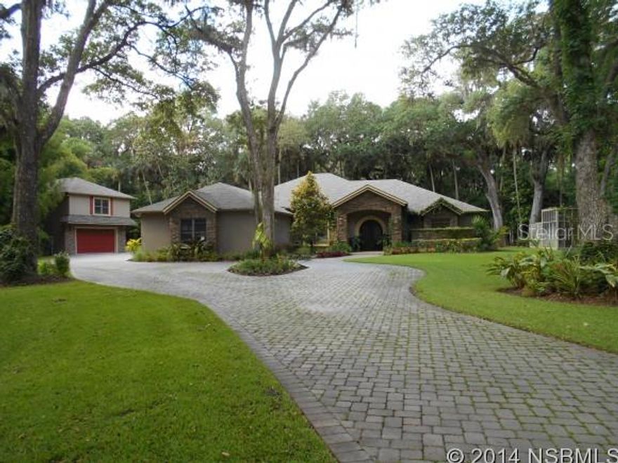 This gated estate home takes your breath away. Custom designed home with a spa type atmosphere. If you enjoy yard with a lake and wildlife this is the home for you and if you love to cook the gourmet kitchen features double oven, breakfast bar and island and a 6 burner gas range. Very open floor plan with 2 car attached garage. A custom built copper tub complete with waterfall and hand-laid stone wall is featured in the master suite. Also there is a detached two car garage which includes 1 bedroom and 1 bath in-law suite above.   Zoned for horses.