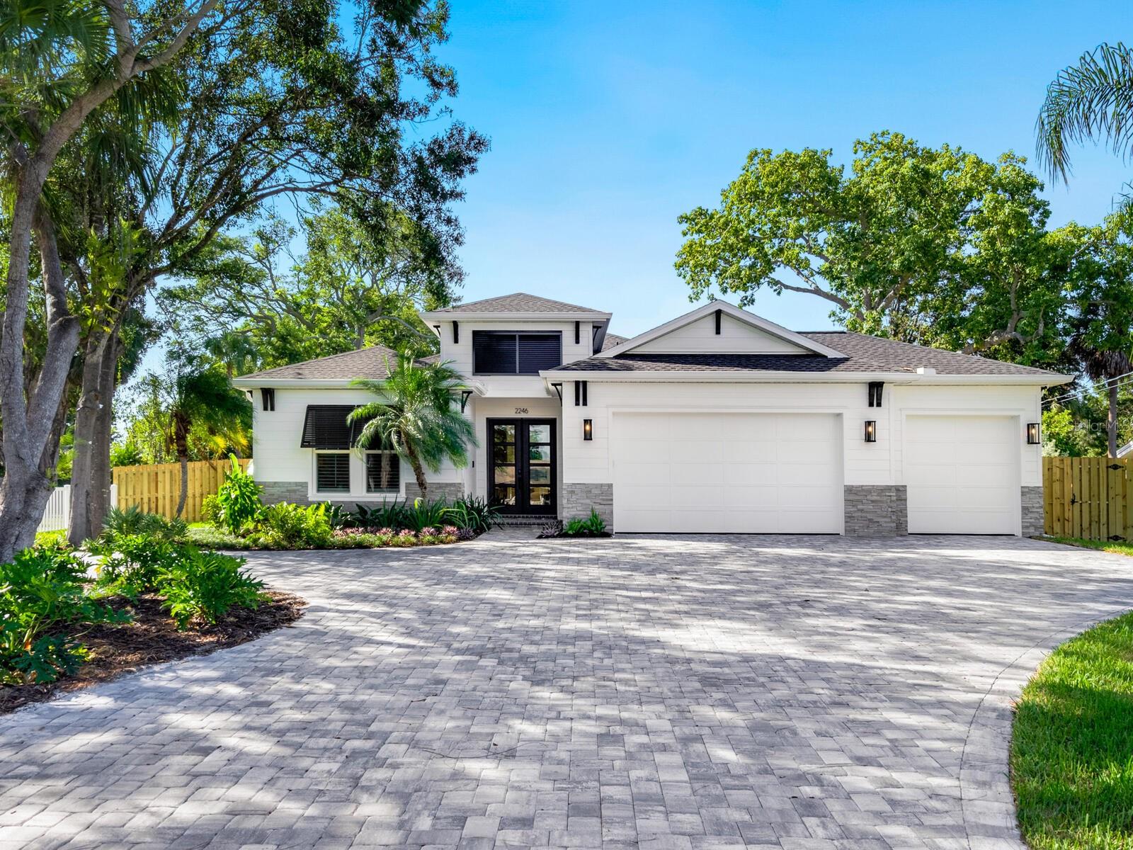Fully furnished option available — this former model home is ready for immediate occupancy! Upon entering this fabulous property with a great East of Trail
location, the welcoming appeal draws you in…from the brick paver drive, the Key West style shutters, the exterior stone accents, the professional
landscaping, and the gorgeous double-door entry to the gallery with 12-foot ceiling and a see-thru view all the way to the pool and beyond. Clean
architecture and a calming neutral décor enhance the stunning details of the 2,252 square foot “Kei Coastal” floor plan for wonderful
indoor/outdoor living. This brand new 3 bedroom, 2.5 bath residence with a flex room and 3-car garage has been thoughtfully planned and
carefully executed by the award-winning team at Allegra Homes, and invites further exploration to appreciate the many delightful amenities. The
family room is accented by wood beam ceiling detail, a recessed niche prewired for a large screen TV, and triple sliders opening wide to the
enclosed lanai with covered living and dining areas. Open to the family room is an impeccably designed island kitchen featuring quartz counters,
top-of-the-line KitchenAid appliances including a wall oven with convection and microwave, 36” electric cooktop, 36” French door refrigerator,
wide backsplash window for natural light, and a spacious dining area with built-in buffet, beverage cooler and awesome pool view. Set apart from
the other bedrooms, the primary suite with dual walk-in closets, tray ceiling and plantation shutters offers a plush setting for quiet enjoyment and
relaxation. The bath is divine with its matte black fixtures, stylish tile flooring, large frameless glass shower, private water closet and double sink
vanity. A flex room with French doors, built-in cabinets and private patio provides space for an office or study. Other notable mentions are
imported wood-look floor tile throughout the main living space, epoxy finished garage floor, irrigation well, 6 ft. privacy fence, home and pool
alarms, 5” cove molding inside tray ceilings, impact Low-E windows and sliding glass doors, and ventilated wood shelves in all closets. This home
will soon become the ultimate haven for those who live there. Come and see for yourself why Allegra Homes is Sarasota’s renown luxury
homebuilder!