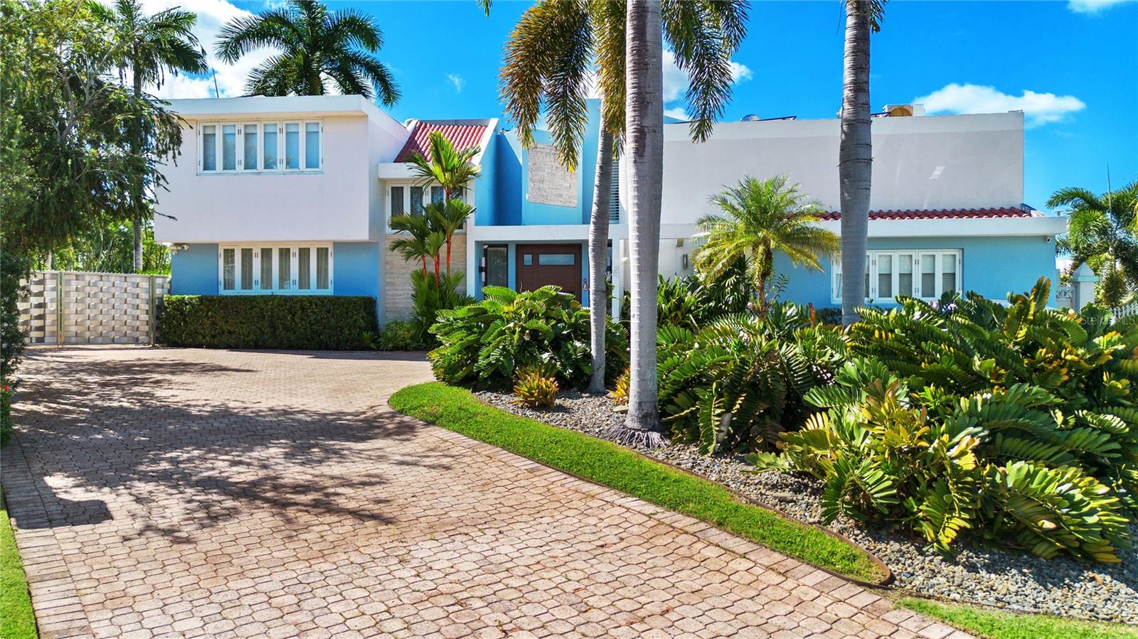 Welcome to this stunning two-story residence in Monte Apolo, a property that perfectly combines privacy, modern design, and convenience. Located on a dead-end street at the highest point in the community, this home offers sweeping views of the city and an unmatched sense of serenity.
This spacious 5-bedroom, 5-bathroom home spans 5,558 sq. ft. on a 1,543 sq. meter lot. The property features a private brick-laid driveway that can accommodate up to eight cars.
Fully furnished with modern aesthetics, the interiors boast a beautifully designed kitchen with wooden cabinetry, granite countertops, and top-of-the-line appliances, centrally located for effortless entertaining.
The home offers ample entertainment areas, including one billiard table on first floor and an outdoor space with a pool, gazebo, and bar. Additional highlights include an 80-bottle wine cellar for wine enthusiasts.
The primary bedroom serves as a retreat, featuring a spacious ensuite bathroom with his-and-hers sinks, a cozy relaxation area with a sofa and TV, and a reading nook with relaxing metropolitan and mountain views.
Most bedrooms include ensuite bathrooms, ensuring comfort and privacy for all occupants. The second floor houses a dedicated gym area and a separate office space, catering to all aspects of life.
Sustainability is a cornerstone of this property, with 44 solar panels, three Tesla batteries, a Tesla electric charger, a 20K diesel generator, a 20K gas generator, and a 1,500-gallon cistern, providing energy efficiency and self-sufficiency.
Monte Apolo provides access control and is conveniently located near the expressway, making it ideal for those who appreciate city life with a touch of privacy. This home is a rare opportunity to create a legacy in a luxurious, energy-efficient residence designed for comfort and entertaining.