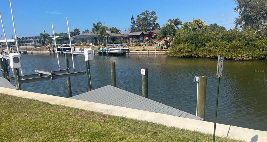 Welcome to a cozy waterfront living opportunity in the highly desired Marina Isles community.  This condo offers panoramic views of the canal and marina and just minutes to shopping, dining, golf courses, and beaches!  Located on the first floor and being an end unit provides easy access and natural lighting.  Enjoy the screened in lanai for coffee or cocktails and walk out to visit the many dolphin/manatee that visit almost daily just steps away.  Water, sewer, cable, internet, heated pool and spa are just a few of what's included in condo fees.  The boat slip has direct access to the intercoastal and Gulf waterways making it a boater's or fisher's dream.  Marina Isles is a very friendly and active community with very low traffic even during the busy seasons.  Why live near the water when you can be on it?  Call or visit today!