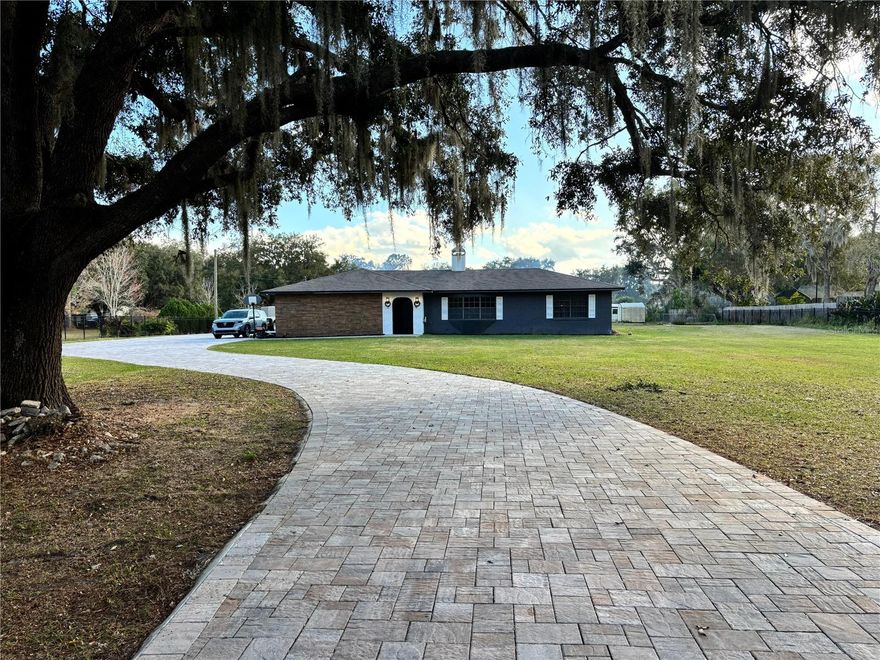 Welcome to your private oasis in the heart of Kissimmee! This stunning, fully remodeled 3-bedroom, 3-bathroom home sits on an expansive 2.4 acres with no HOA or CDD—offering freedom, space, and endless possibilities. Enjoy peaceful living with the convenience of a public boat ramp right on the street, perfect for weekend adventures on the water.

This home features numerous upgrades, including a new roof in 2018, new more potent AC in 2024, and a new water softener for peace of mind. The property is fully fenced with a gated entrance and boasts an extended brick-paver driveway. A pool safety fence adds extra security, while the impressive 50-foot covered lanai patio is perfect for hosting gatherings or relaxing outdoors. Additional highlights include two storage sheds, providing plenty of space for tools, toys, or equipment. Centrally located yet wonderfully private, this rare property offers the best of Florida living.