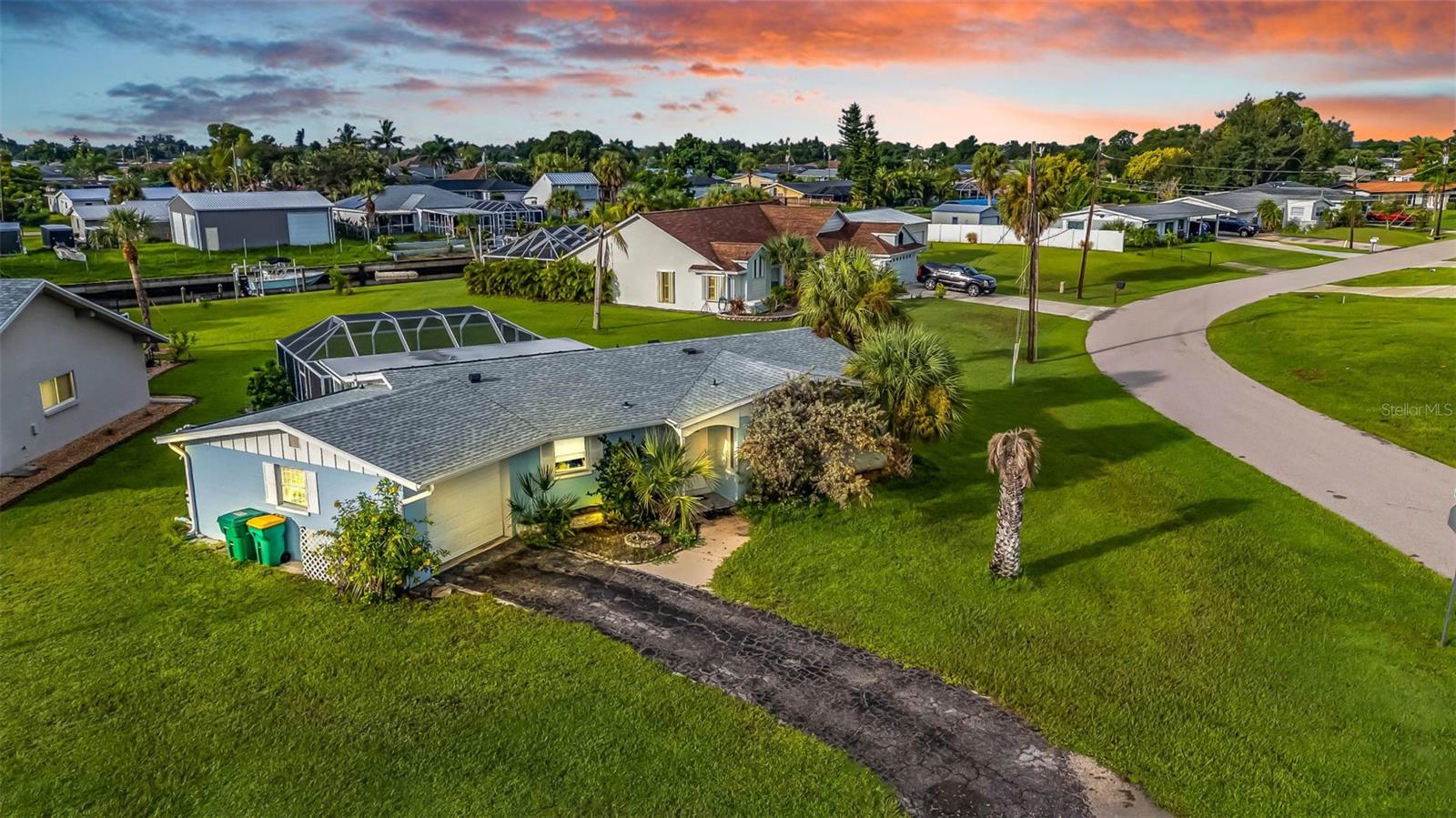 Pride of Ownership gleams through every detail of this charming Southwest Florida cottage, perfectly placed on an oversized corner lot. Blending timeless quality with the relaxed SWFL Island lifestyle, this home offers the best of both worlds.
Inside, the true star is the original terrazzo floors, polished to perfection and glowing with character that endures. Sunlight dances across these gleaming floors, highlighting spacious living and dining areas that connect seamlessly with the kitchen and Florida room. 2 comfortable bedrooms and 2 full baths provide space for family and guests, while the the 2023 shingle roof shelters you overhead with the garage and laundry area adding convenience.
Outdoors, the magic continues. Picture yourself sipping morning coffee in the shade of your lanai, or enjoying an ice-cold umbrella drink by the sparkling screened pool, as you take in peaceful canal views. All the beauty of the water is yours without the higher costs of direct frontage. And with a history of never flooding, this home brings both charm and peace of mind.
Conveniently located near Port Charlotte Beach Park, boat ramps, shopping, and dining, this home is also just over the bridge to the award-winning Punta Gorda small-town food scene. Here, lifestyle, comfort, and community come together in one perfect package. It’s time to stop dreaming and start LIVING your slice of Florida paradise sunshine days today!