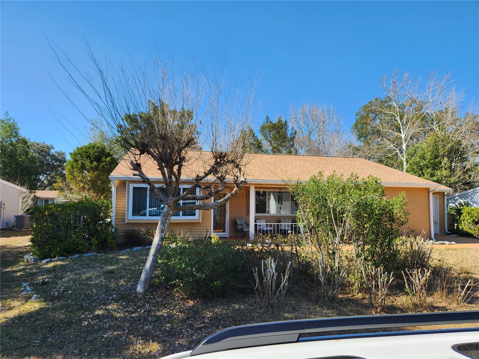 With a little love, this could be a great snowbird nest or investment home. 2 KING SIZE MASTER SUITES each with attached bathrooms and walk in closets. Nice BIG front porch. Large living room with high ceilings open to a formal dining area. Kitchen has a window for more light and looks into the mature landscaped backyard. Off of the living room, dining room and 2nd bedroom are sliders to a good size Florida Room. ROOF Replaced in 2022 and AC in 2014. Just a hop, skip and a jump right around the corner is the pool, hot tubs, library, billiards, card and craft room. Also the tennis, pickleball, volleyball, horseshoe, shuffleboard, and bocce courts. Community also offers another 5 pools, 4 hot tubs, Restaurant, Golf Course, Dog Park and 2 other fitness centers plus 2 auditoriums for community events including BINGO. House is extremely close to WalMart, shopping, restaurants, and medical facilities. At this price this house won't last. Very motivated sellers too! So come take a look fast before its gone!