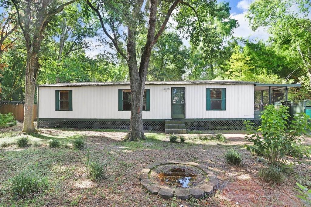 Looking for a project with strong potential? This half-acre, fully fenced lot with gated entry and NO HOA is your chance to create value and build equity just 30 minutes from downtown Tampa.
This is a cash-only deal. The property features a manufactured home that needs work, making it ideal for investors ready to flip, remodel, or hold as a rental for steady cash flow. This home provides a wonderful opportunity for renovation and customization to make your own features and special touches. Includes multiple sheds, a custom chicken coop, and mature landscaping with ponds, native plants, and walking paths.
With no HOA restrictions, you’ll have the freedom to improve, expand, or reimagine the property to suit your goals.
Conveniently located near Wesley Chapel’s shopping, dining, and amenities, Minutes away from I-75 highway. Whether you’re looking for an affordable place to call home or a great investment opportunity. This home has it all.