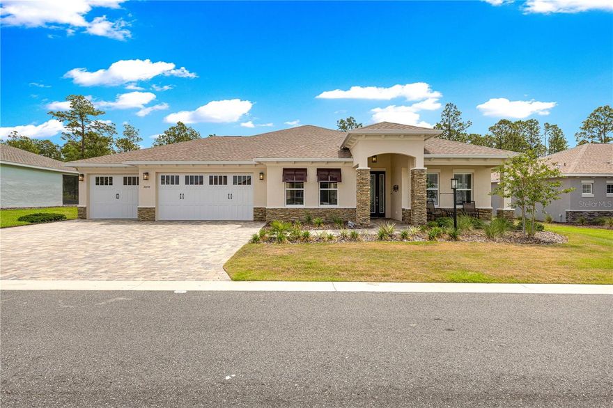 Located in On Top of the World, this exceptional Arlington model offers the perfect blend of comfort, flexibility, and Florida lifestyle living. Featuring 3 spacious bedrooms, each with its own private bath, plus a versatile flex room and inviting sunroom, this home is designed to accommodate both everyday living and entertaining with ease.  The beautifully appointed kitchen features quartz countertops, top-of-the-line appliances, a walk-in pantry, and even includes an additional freezer in the garage for extra storage convenience. A Kenetico Reverse Osmosis system adds another level of quality and peace of mind.  One of the standout features is the additional air-conditioned room located in the garage — ideal for a game room, man cave, she shed, workshop, hobby space, fitness area, or creative studio. The oversized 2-car garage also includes a dedicated golf cart garage, and the golf cart is included with the home.  Step outside to enjoy the peaceful patio area overlooking woods and green space, creating a private and relaxing outdoor setting with no rear neighbors directly behind you.  
Located just a short golf cart ride from The Summit amenities center, residents enjoy access to an incredible variety of activities and amenities including pools, golf, pickleball, softball, fitness centers, woodworking, crafts, clubs, social events, and frequent live entertainment.  This home offers the lifestyle so many buyers come to Ocala to find — active, social, and surrounded by natural beauty.