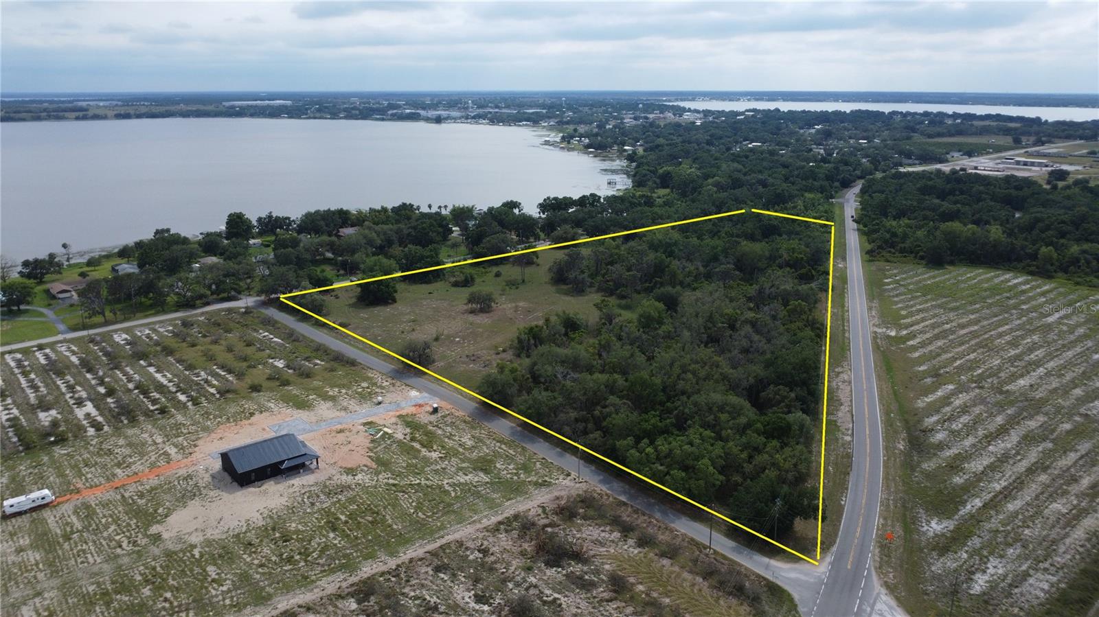17 acres of truly prime real estate in the easternmost portion of Frostproof (pop. 2877), with a quarter mile of lakeview residential frontage on upscale North Lake Reedy Boulevard, and well over a quarter mile of highway frontage with hard corner on County Road 630, a primary arterial corridor between south Polk and Highlands Counties and Florida’s Treasure Coast. The City of Frostproof is currently expanding the public water system, with sufficient capacity for development on this parcel. Tremendous potential for homesites a stone’s throw from the lake on the south side, commercial use such as RV storage or retail on the increasingly-busy highway, and sufficient buffer (e.g. green space, clubhouse/pool) in between to preserve the tranquility of the homesites. Gorgeous, sand-bottomed, 3500 acre Lake Reedy is literally across the street, with a county park with paved boat ramp less than a quarter mile down the shore. Polk County’s explosive growth is no secret, nor is the scarcity of access to the east. To the north are Interstate 4 and US 17-92, both often impassable with traffic. State Road 60 extends eastward from Lake Wales, and US 98 goes southeast from Sebring. That’s it. Except for County Road 630, a feeder route to State Road 60 which provides eastward access for those between Lake Wales and Sebring. As this unprecedented growth continues, County Road 630 and still-rural Frostproof are directly in the crosshairs. Homes are now being constructed in the vicinity of this parcel. Now is the time to get out in front of the inevitable, and seize this opportunity while it’s available! * * * The two parcels that compose this property are now available separately!