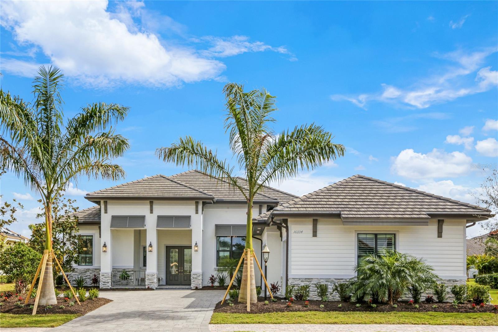 Under contract-accepting backup offers. We are happy to introduce a unique home in one of the most sought after enclaves within lower Lakewood Ranch, Eagles Cliff at Country Club East. Stunning benefits around every corner, the popular Chandler model by Stock Development stands at 4 bedrooms, 4.5 bathrooms, 3 car garage and almost 3,200 square feet. Just built in 2019, the home has barely been lived in. Discerning buyers will truly see the thoughtful upgrades throughout including: 76 ft wide lot with a very private orientation, oversize pool with edge to edge water (no coping), extended patio, impact windows throughout and electronic shades. This home also features all the premium enhancements new home owners would expect, gourmet kitchen, gorgeous countertops, generous pantry, coffered ceilings, corner sliders, spacious den/office and much, much more, priced below comparable homes in other communities. Country Club East is a high-end, gated community that offers residents a diverse range of amenities including a clubhouse, optional golf, restaurant, fitness center, three community pools, playground, dog park, walking trails and more! Prime neighborhood geography gives you easy access to downtown Waterside Place, downtown Lakewood Ranch, the new Center Point development, University Town Center, and more.