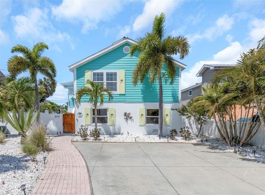 Located in the heart of downtown Gulfport, this 21st century Key West-style elevated home is picture perfect and blends seamlessly with the area’s eclectic charm. A custom wood gate welcomes you into a large, ultra-private courtyard filled with tropical plantings, creating a serene and beautiful setting that truly sets this home apart. Surrounded by masonry walls, this inviting outdoor space leads to the staircase up to the main living level.

Upstairs, an open floor plan connects the living, dining, and kitchen areas, all enhanced by vaulted ceilings and easy-care laminate flooring throughout. The kitchen features ample cabinetry, stone countertops, stainless steel appliances, and a center island, ideal for cooking, gathering, and entertaining. The spacious living room offers high ceilings and sliding doors that open to an expansive covered balcony.

Designed with a split-bedroom layout, this home offers two bedrooms and two bathrooms. The primary suite includes a large walk-in closet, en suite bath with double sinks, a separate tub and shower, and private access to the balcony. The second bedroom is tucked away on the opposite side of the home and features vaulted ceilings and its own generous walk-in closet.

The 35-foot covered balcony spans the entire south side of the home, overlooking the courtyard below, perfect for relaxing or entertaining.

The entire lower level is enclosed and offers exceptional versatility, including an oversized two-car garage with newly epoxied floors, automatic garage door openers, hurricane-rated windows, and flood gates for added peace of mind. A spacious 16’ x 25’ unconditioned bonus room provides endless potential for storage, a workshop, art studio, or creative space.

Outside, the expansive courtyard is truly an entertainer’s dream, complete with a 28-foot covered patio and surrounded by vibrant tropical greenery. The property also features alley access to the garage and a four-car off-street parking pad in front. The front yard is thoughtfully designed with xeriscaping and Florida-friendly plants, complemented by a drip irrigation system for easy, low-maintenance care.

All of this just steps from everything downtown Gulfport has to offer—shopping, dining, the beach, fishing pier, vibrant seasonal events, and more.

All room measurements are approximate and should be verified by Buyer.