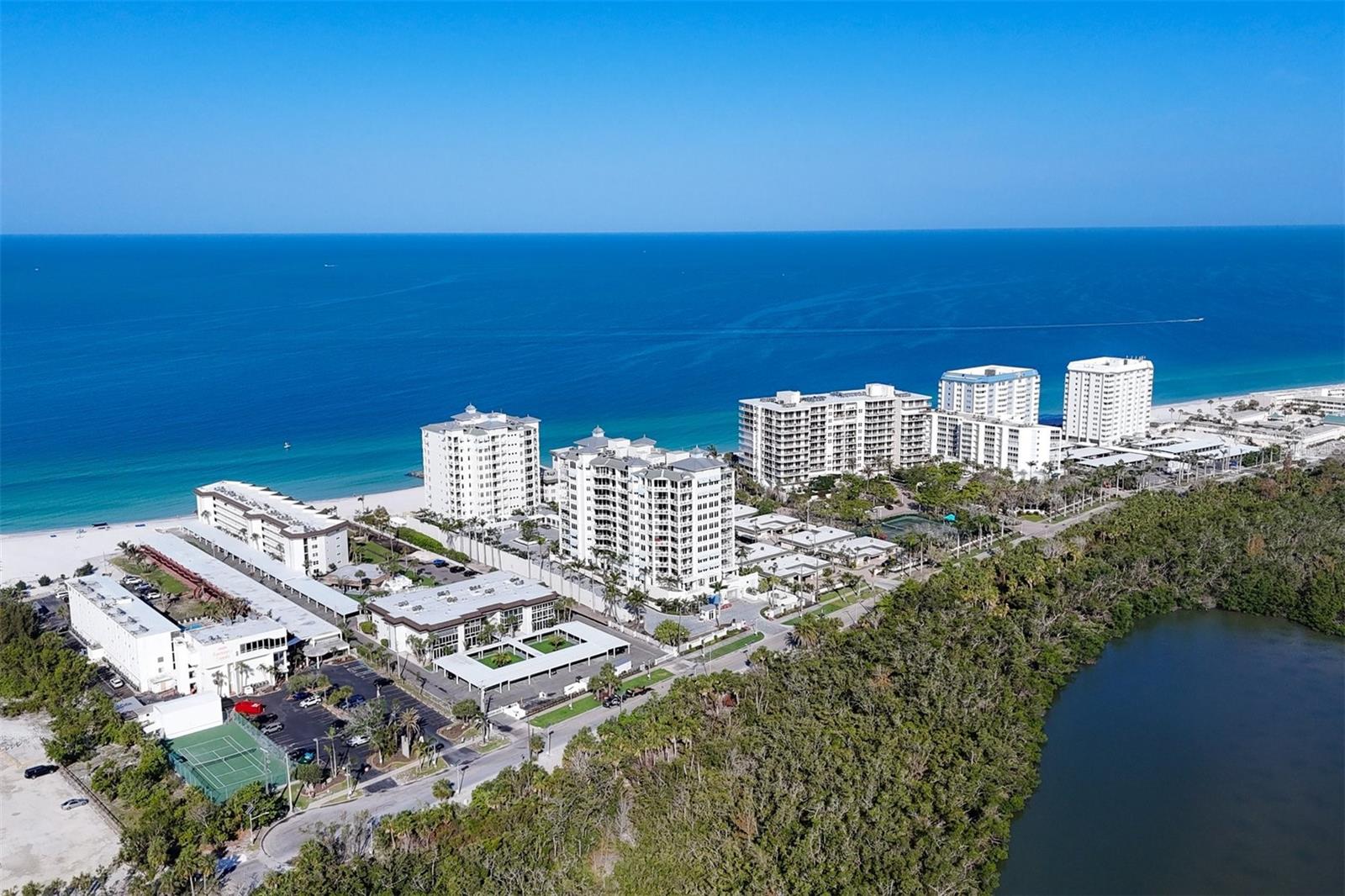 Unique opportunity to rent! A fully remodeled beach condo at an incredible discount. Renovations include a totally new kitchen with custom cabinets…complete with glass display doors and wine rack, quartz countertops, stainless appliances, subway backsplash, and breakfast bar, new bathrooms in both guest and owners suite, luxury vinyl plank flooring, new paint and trim. The unit has a drybar at the entry. The upgrades include luxury vinyl planking, new doors, new fans and light fixtures. It even has its own washer and dryer. The glass enclosed lanai and all windows are impact glass. The condo has a view of the pool, a peek of the gulf and is flooded with natural light. It’s tastefully decorated and is being offered turnkey furnished. It offers two storage units for all of your beach toys ...one on the enclosed lanai and one in the association storage room. Lido Harbour South is a
