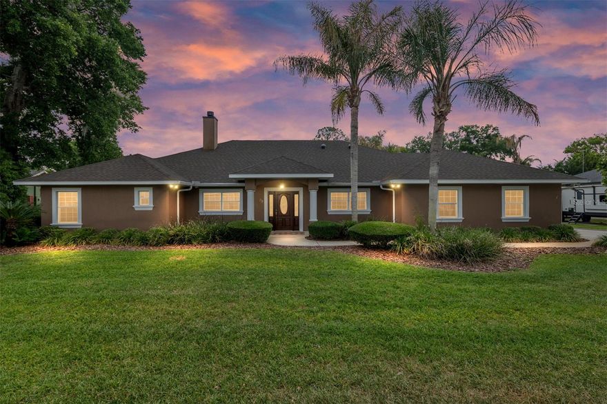 Welcome to your private lake retreat—where comfort, efficiency, and resort-style living
come together. This beautifully designed 4-bedroom, 2-bath home also features a dedicated
office (or optional 4th bedroom), gym, and spacious game room, offering flexibility for both
everyday living and entertaining.
Step inside to a thoughtfully designed open floor plan that creates a seamless flow between
the living room, kitchen, and game room—all with stunning views of the pool and outdoor
living spaces. The kitchen serves as the heart of the home, featuring vaulted ceilings, granite
countertops, custom maple cabinetry, and premium appliances including a KitchenAid
refrigerator, built-in oven and microwave combo, glass cooktop, and Bosch dishwasher.
The living room is warm and inviting with a vaulted ceiling, wood-burning fireplace with gas
log igniter, built-in entertainment center, surround sound, and a 70” Samsung TV—perfect
for relaxing or hosting guests.
Retreat to the luxurious master suite, complete with a cozy window bench with storage, built-
in speakers, a large walk-in closet, and custom cabinetry. The spa-inspired bathroom
features a jetted garden tub, an oversized 6’x6’ dual walk-in shower, and elegant manmade
marble finishes throughout.
Built for efficiency and peace of mind, this home includes insulated concrete form walls with
a 6” concrete core, Icynene attic insulation, solar photovoltaic system, solar hot water 11/09,
energy-efficient Low-E windows, and a 4-ton Trane AC system 9/2015.  Enjoy exceptionally low
electric bills averaging just $150/month. Additional features include smart home wiring, a
monitored alarm system, built-in safe, and a newer roof (2021).
Step outside to your own private oasis. The custom saltwater pool with aggregate finish is
solar heated and enclosed within a screened lanai, complemented by a brick paver deck
and a fully equipped outdoor kitchen with grill, side burner, and sink—ideal for year-round
entertaining.
Enjoy true lake living with two personal watercraft lifts, a covered boathouse with electric
winch, durable seawalls, and a lake-fed irrigation system. The extensively landscaped
grounds provide exceptional privacy, while brick paver walkways and a fire pit create the
perfect setting for relaxing evenings by the water. Additional highlights include a fully equipped game room with granite counters and a
slate/hardwood pool table, a utility room with second refrigerator and custom cabinetry, and
a 2-car garage with workshop space and water softener system.
This one-of-a-kind lake property offers the perfect blend of luxury, functionality, and energy
efficiency—designed for making memories and enjoying the best of waterfront living.