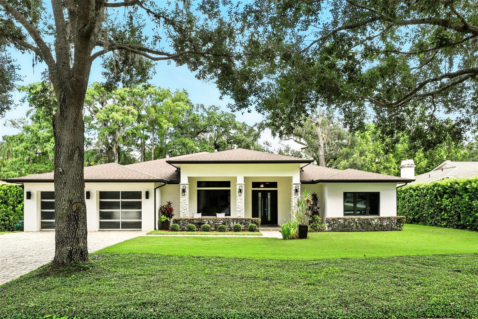 Stunning canal-front home, Winter Park Chain of Lakes. Welcome to this exceptional one-story residence in the heart of Winter Park, offering direct access to the desired Winter Park Chain of Lakes via the Venetian Canal. Built in 2018, this meticulously maintained home features four bedrooms, three baths, and 3,258 square feet of elegant living space designed for comfort and entertaining. The open floor plan showcases a large gourmet kitchen outfitted with custom cabinetry and generous counter space. Ideal for hosting gatherings or enjoying quiet evenings at home. Expansive windows throughout the home offer beautiful, tranquil views of the canal and lush, mature landscaping. Large screened-in lanai complete with a fully equipped summer kitchen and fireplace overlooking the canal and private boathouse.