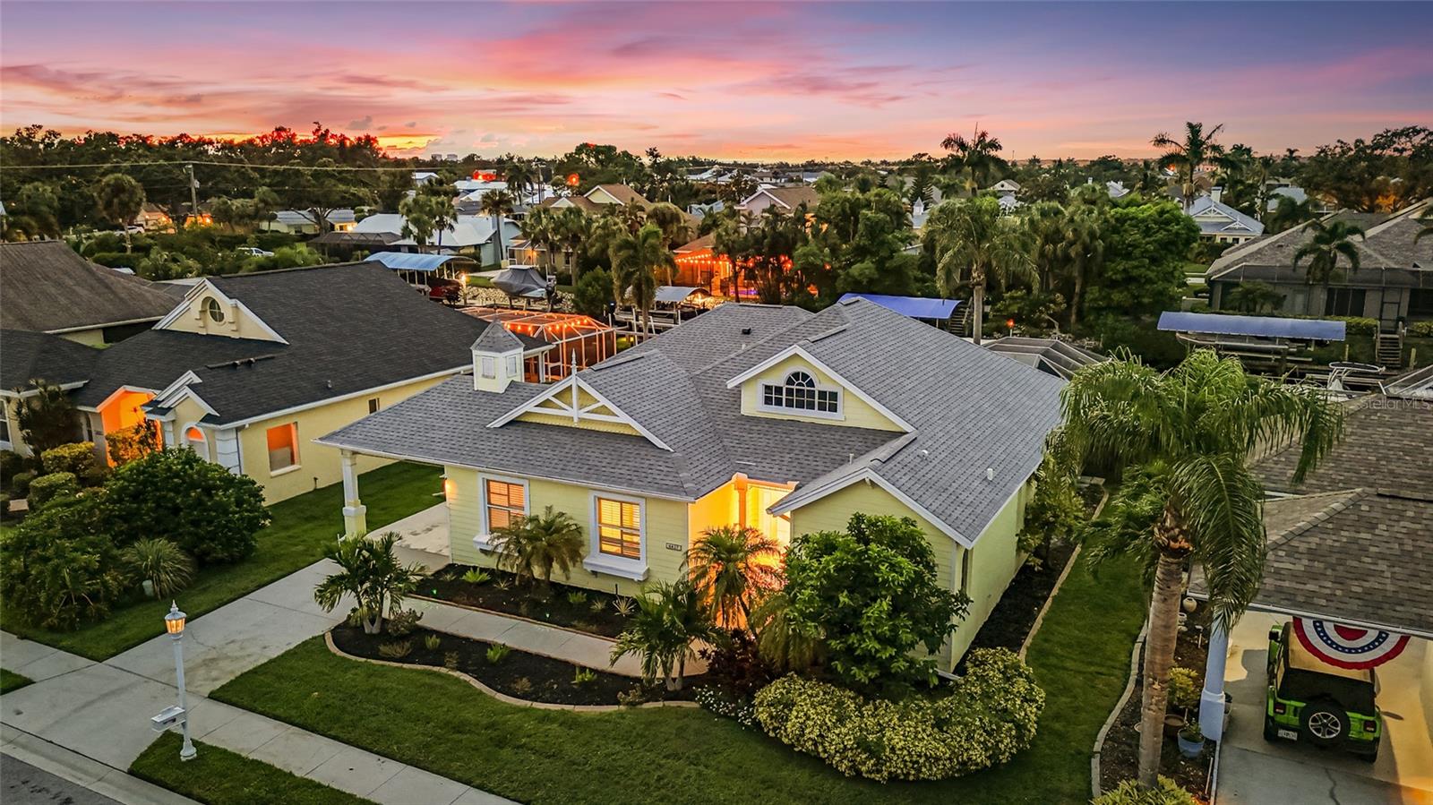 Experience the pinnacle of Florida waterfront living in this elegant Classic Key West style 4BR/3BA, 2,456 sq. ft. residence in the coveted boating community of The Inlets. Designed for the discerning water enthusiast, the high-performance extended-cover dock with 12,000-lb aluminum lift accommodates large vessels with ease, offering direct, swift access to the Manatee River, Intracoastal Waterway, and Gulf of Mexico. Your private saltwater canal setting invites endless days of luxury fish from your dock, embark on a sunset cruise, paddleboard, kayak, or simply unwind beside the sparkling saltwater pool. Two-tiered decks and lush tropical surroundings create an entertainer's paradise for alfresco dining and sun-soaked relaxation. Inside, a flexible floor plan allows for an in-law suite or private office, while expansive sliding glass doors and an air-conditioned Florida room seamlessly merge indoor and outdoor living. Recent enhancements include a high-efficiency HVAC, gas water heater, and upgraded garage door. Residents of The Inlets enjoy exclusive access to tennis courts, a playground, and a picturesque waterfront park. With low HOA, no CDD, and an unbeatable location minutes from I-75, world-class beaches, fine dining, and three major airports, this is your opportunity to drop anchor and indulge in the nautical lifestyle you've always dreamed of.