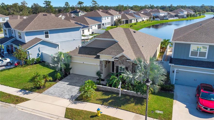 Here you will find a Waterfront Paradise with Resort-Style Pool in Sawyers Landing. Welcome to this stunning waterfront 3-bedroom, 2-bathroom home, built in 2020 and located in the highly sought-after Sawyers Landing community. With breathtaking water views from your poolside oasis, this contemporary home offers the perfect blend of modern design, luxury, and functional living. Step inside to find soaring nine-foot ceilings and elegant crown molding, creating an open and inviting atmosphere. The expansive windows not only flood the home with natural light but also offer stunning views of the water, bringing a sense of tranquility into every room. The open floor plan is ideal for both everyday living and entertaining, with a chef’s kitchen featuring a massive 15-foot island and stainless steel appliances—perfect for hosting gatherings or preparing meals with a view. The primary suite is a true retreat, featuring a tray ceiling and a spa-like bathroom with modern fixtures and a walk-in shower with three showerheads. The home is tiled throughout, except for the cozy, carpeted guest bedrooms. Large hurricane-impact windows with plantation shutters enhance both safety and style while maximizing your connection to the outdoor scenery. Step outside to your private backyard oasis, where the heated dual-waterfall pool and spa create a serene, resort-like setting. The tiki-inspired design enhances the ambiance, while the open-air lanai with retractable hurricane-rated screens allows for year-round enjoyment. The home is equipped with solar panels, providing sustainable and cost-efficient energy. Whether you’re lounging poolside, dining al fresco, or simply unwinding, you’ll be treated to gorgeous water views and breathtaking sunsets right from your backyard. Additional features include a spacious two-car garage, a treated driveway for enhanced curb appeal, and secure locked storage areas on both sides of the house to keep outdoor belongings neatly tucked away. Located in Deland, this exceptional waterfront home offers easy access to shopping, dining, and New Smyrna Beach, all while enjoying the peace, privacy, and beauty of waterfront living. Don’t miss your chance to own this rare waterfront retreat—schedule a showing today and experience the best of Florida living!