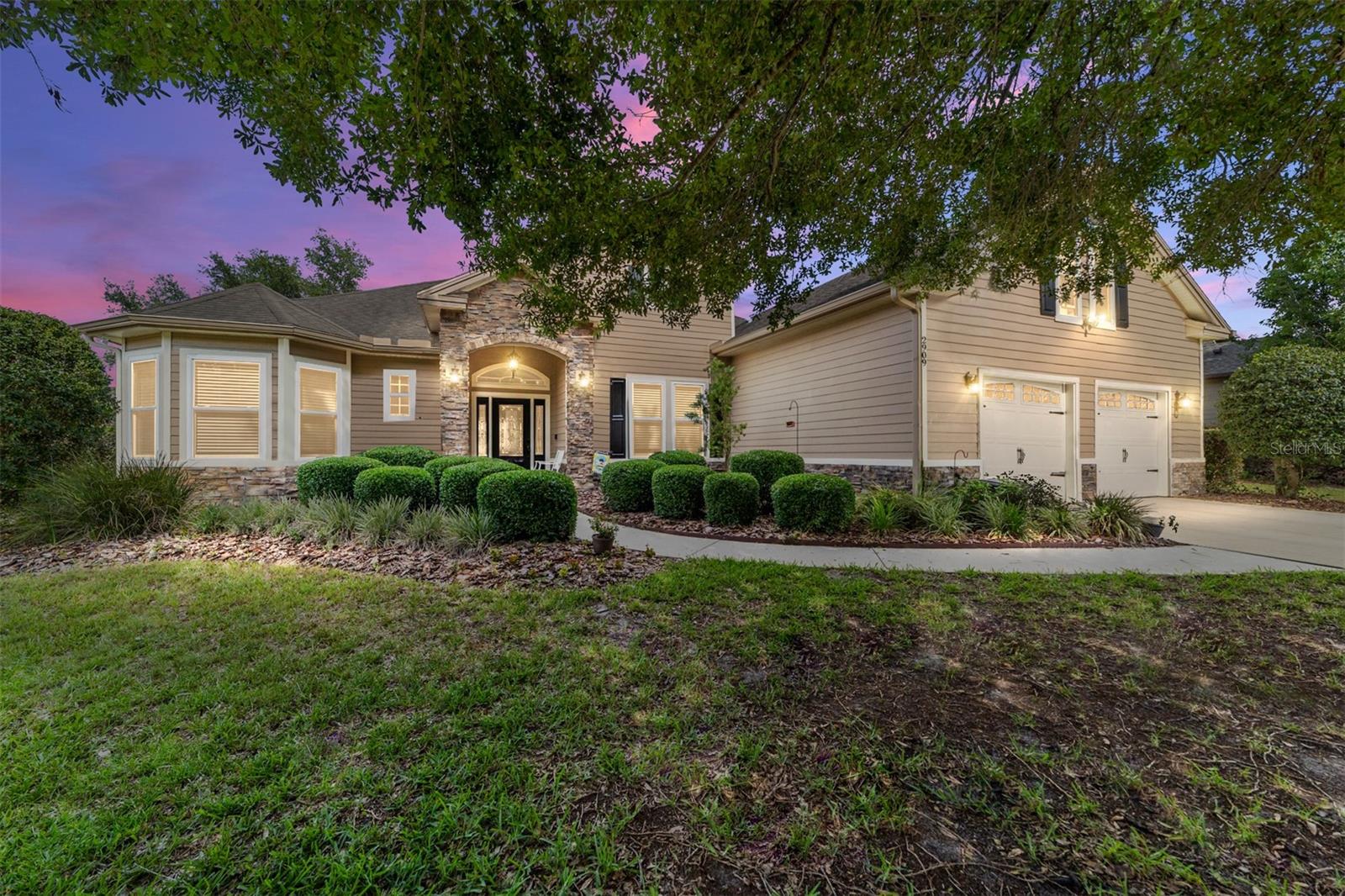 PAID-IN-FULL Solar + Tesla Powerwall = Energy Independence & Long-Term Savings! This former Parade of Homes Showcase offers the rare combination of luxury, energy efficiency, and a premier location. Situated in the highly desirable Caraway neighborhood, this meticulously maintained 4-bedroom, 3.5-bathroom residence features the largest floor plan in the community, with over 2,860 square feet of thoughtfully designed living space. What truly sets this home apart is its fully paid-off solar panel system and Tesla Powerwall backup battery, which will convey to the new owner at closing. With no loan or lease to assume, buyers will enjoy significant long-term savings and energy independence—an exceptional value for today's homeowner.
Inside, the home features soaring 10-foot ceilings, 18-inch tile flooring, extensive crown molding, and an abundance of natural light throughout. The gourmet kitchen is appointed with solid maple cabinetry, granite countertops, stainless steel appliances, a breakfast bar, and a cozy dining nook. Entertain with ease in the formal living and dining rooms, or relax in the spacious great room complete with a wood-burning fireplace. The split-bedroom layout includes a luxurious primary suite with dual walk-in closets, a jetted soaking tub, separate shower, and dual vanities. A built-in office nook and custom wine rack add function and character, while the upstairs guest suite offers a private retreat, ideal for you OR your visiting guests.
Step outside to a private, fully fenced backyard featuring a brick paver lanai, perfect for enjoying Florida evenings. The backyard features direct access to the bathroom, especially convenient when entertaining guests, Additional recent updates include a professionally painted exterior in 2025, new HVAC system in 2021, new windows in 2020, and new gutters in 2022. The oversized garage provides ample storage space with a large storage closet, and the seller is offering a roof credit with an acceptable offer.
Located just minutes from UF Health, the University of Florida, the VA Hospital, and top-rated schools, this home offers unmatched value, convenience, and peace of mind. A rare opportunity to own a high-performing, beautifully upgraded home in one of Gainesville’s most sought-after neighborhoods.