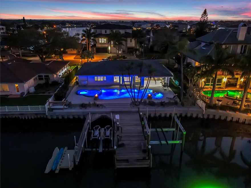 Under contract-accepting backup offers. SELLER FINANCING AVAILABLE WITH FAVOURABLE RATE. Welcome to 906 Oakwood Drive! This home is a true outdoor enthusiast’s paradise. The homeowner has recently added a brand new 16,000 lbs. boat lift to the already existing lift plus a kayak dock/launch. Take a dip in the recently built, resort style saltwater pool and spa, featuring a splash pad, fire bowls and built- in seating. No expense has been spared creating the outdoor kitchen featuring top of the line Hestan appliances including a gas grill, prep area, refrigerator, pizza oven, smoker and so much more. You have to see it to really appreciate this custom outdoor living space. When entering the home from the backyard you will find a spacious Florida Room with a wide open water view. Most everything in this home has been updated including a brand new kitchen with top off the line gas stove, beautiful wood cabinets and quartz countertops. This home has 2 bedrooms with beautifully remodeled en suites, so you have a choice as to which one you choose as the master. The third bedroom has a built in Murphy bed and desk to maximize the space when it is not needed as a bedroom but easily converted for guests. When you first drive up to the home you will notice brand new windows, pavers, landscaping, roof, fencing, entry door and so much more (complete list of upgrades available). A whole house gas generator was recently added as well. The home has been remodeled from top to bottom by a homeowner who values quality work and the finer things in life. All of this in close proximity to the beach, shopping, medical facilities and grocery stores. Don’t hesitate to schedule your private tour of this impeccable home with stunning views.