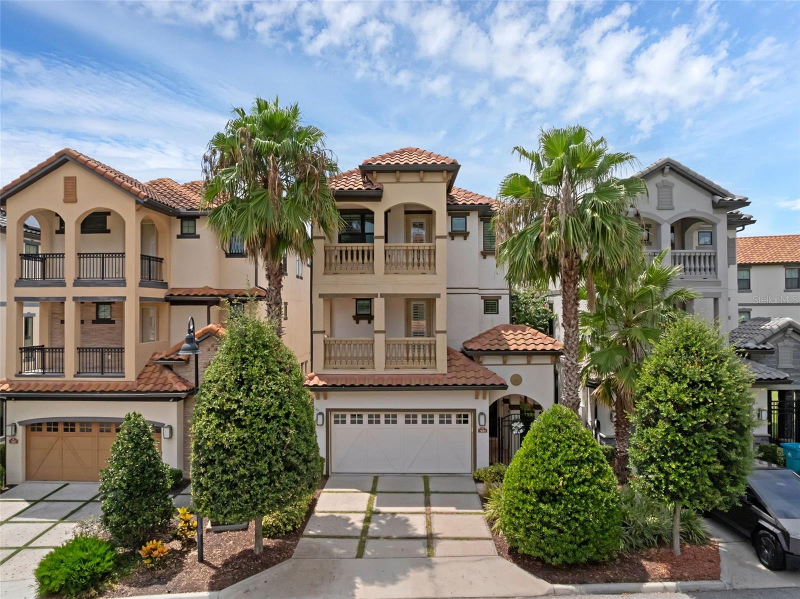 Luxury Lakefront Living in the Heart of Dr. Phillips. Welcome to Lakeside at Toscana, an exclusive gated community nestled along the tranquil shores of Spring Lake. This exceptional three-story lakefront estate offers 6 bedrooms, 6 bathrooms, and panoramic water views from every level. Unwind each evening with a breathtaking sunset, as you take in the peaceful sights and sounds of the wildlife. The dramatic two-story foyer sets the tone with sweeping views of the infinity-edge heated saltwater pool, tiered lanai, and tranquil lake beyond. Both elegant staircases and a private elevator connect all three levels. The gourmet kitchen is a chef’s dream, featuring quartz countertops, a spacious island with breakfast bar, gas range with pot filler, JennAir appliances, custom cabinetry, an eat-in nook, formal dining room, and a walk-in pantry with a second refrigerator. The first floor also offers a spacious great room, guest bedroom, and a full bath. On the second floor, you'll find three generously sized bedrooms, a living area, and a balcony overlooking Spring Lake—perfect for enjoying serene morning views or Disney Fireworks. This level also features a dedicated laundry room for added convenience. The third floor serves as your private retreat, featuring two luxurious primary suites designed for comfort and privacy. Each suite includes a spacious en-suite bathroom with dual vanities, a garden tub, and a separate walk-in shower. One suite enjoys a private balcony with tranquil lake views, while the other overlooks the picturesque neighborhood—perfect for enjoying peaceful mornings or quiet evenings. A second laundry room is also located on this level for added functionality. Thoughtful upgrades throughout the home include lush bamboo landscaping for enhanced privacy, Hunter Douglas electric shades, hurricane-rated doors, smart wiring, and an EV charger in the garage. All of the walk-in closets are custom-built with ample storage. Additional features include three recently serviced A/C units with a transferable service agreement and a removable pool safety fence for added peace of mind. Residents enjoy resort-style amenities including a community pool, fitness center, and maintenance-free landscaping. Ideally located near I-4, Restaurant Row, Universal, SeaWorld, and Disney, this home delivers the perfect blend of luxury, location, and lifestyle. Schedule your private tour today—this extraordinary lakefront home won’t last long!