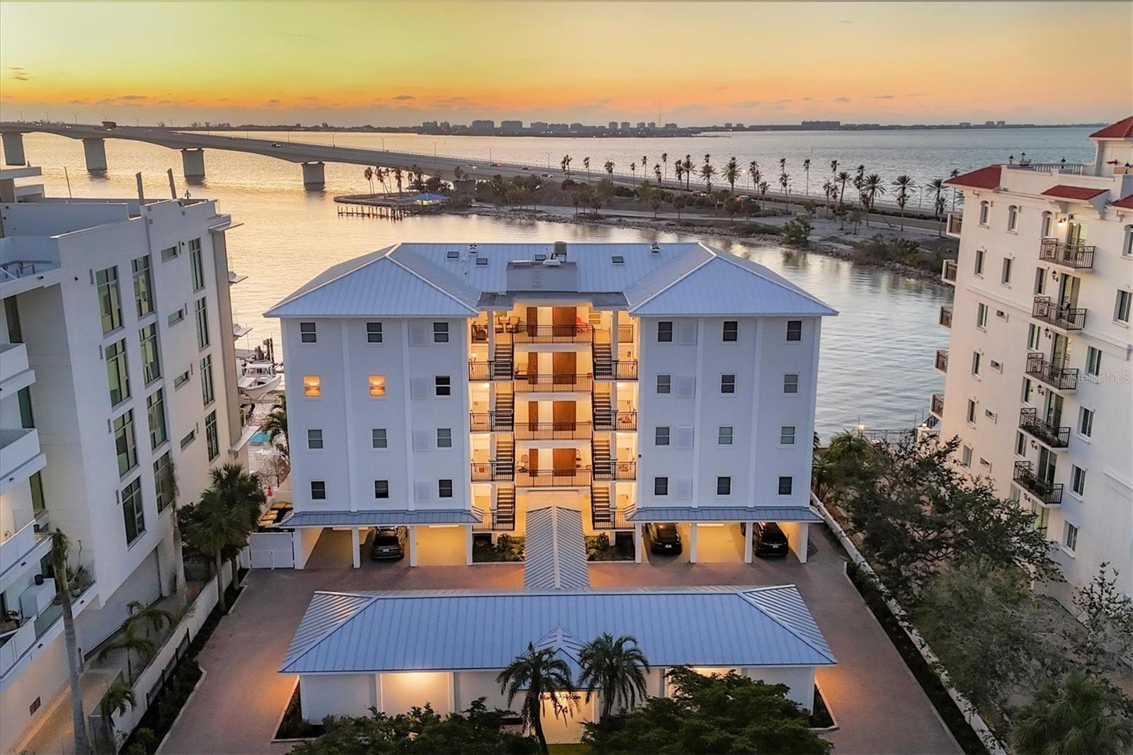 Located in the heart of downtown Sarasota, this exceptional 3-bedroom, 2-bath condominium offers stunning, unobstructed views of Sarasota Bay. You will enjoy 180-degree panoramas of the sparkling water on your personal paver patio, creating the perfect backdrop for relaxed living or entertaining. This boutique building, with only 13 units, has recently undergone a meticulous exterior renovation overseen by an engineering company. Upon arrival, you're greeted by newly professionally landscaped grounds, and your covered parking space provides direct access to your unit via a side entrance for convenience when bringing packages or groceries into the unit. Inside the condominium, the bay views are visible through oversized windows and brand-new impact sliders installed in 2024. Fully renovated in 2018, this home was taken down to the studs, with new drywall, ceilings, lighting, plumbing, and electrical. The open-concept layout flows seamlessly, providing water views from every seat—perfect for both casual living and elegant entertaining. The chef’s kitchen features sleek stainless steel appliances, quartz countertops, a dry bar, and ample storage. Throughout the unit, you'll find custom crown molding and plantation shutters on every window, adding an extra touch of elegance. Each bedroom has its own water view, with the expansive primary suite offering a custom walk-in closet and a luxurious en-suite bathroom complete with a glass walk-in shower, double vanity with marble countertops, and elegant finishes. The two guest bedrooms are generously sized, each featuring large closets for additional storage, and they share a well-appointed bathroom with a glass shower/tub combination, custom white cabinetry, and quartz countertops. Step outside through the sliding glass doors to your wraparound paver patio, where you can watch playful dolphins, boats gliding beneath the bridge, or simply enjoy the breathtaking sunsets. A retractable awning provides shade when needed, while a set of tall palms offers added privacy. There's also a convenient storage shed on the patio, perfect for keeping your beach chairs and fishing gear easily accessible. Residents of 174 Golden Gate Point have exclusive access to a community day dock, ideal for hopping on a boat or enjoying the bay from a close vantage point. The building also features a common room and two additional paver patios, perfect for social gatherings or relaxing with neighbors. Nestled within the picturesque, waterfront community of Golden Gate Point, this condominium offers a tranquil, neighborhood atmosphere surrounded by water, walking paths, and lush landscaping. Yet, it's just moments away from downtown Sarasota's vibrant cultural offerings, fine dining, boutique shopping, and top-tier restaurants.
Experience the perfect blend of luxury, tranquility, and convenience at 174 Golden Gate Point — your waterfront oasis in downtown Sarasota.
