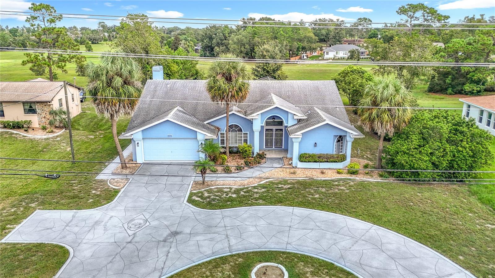 Discover your dream home at 9529 Northcliffe Blvd, Spring Hill, FL 34608, a stunning single-story residence boasting 2,523 square feet of beautifully designed living space. This inviting 3-bedroom, 2-bathroom home features a spacious attached 2-car garage & circular driveway, perfect for modern living. The heart of the home is its tastefully updated kitchen, complete with sleek granite countertops, stainless steel appliances, and elegant wood cabinets adorned with crown molding. Family room with fireplace and vaulted ceiling. The master suite offers a luxurious retreat with a bathroom showcasing dual sinks, a relaxing garden tub, and a separate shower. Step outside to enjoy the serene screen-enclosed inground pool and covered patio, perfect for entertaining or unwinding while overlooking the picturesque Oak Hills Golf Course. Located in the vibrant Spring Hill community, this home is just minutes from an array of attractions within a 20-mile radius. Nature enthusiasts will love Weeki Wachee Springs State Park (8 miles), famous for its mermaid shows and kayaking adventures, and Pine Island Beach (12 miles), a tranquil Gulf Coast gem. For family fun, the Show Palace Dinner Theatre (7 miles) and Hernando Heritage Museum (6 miles) offer cultural experiences, while nearby shopping and dining at Coastal Way Plaza (5 miles) cater to everyday needs. With its blend of modern elegance, outdoor leisure, and proximity to local treasures, 9529 Northcliffe Blvd is more than a home—it's a lifestyle waiting for you.
