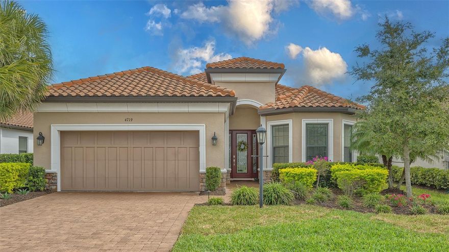 Located in Azario Esplanade, one of Lakewood Ranch’s premier resort-style communities, this impeccably maintained three-bedroom, three-bath residence with a private office offers the thoughtfully designed Lazio open floor plan by Taylor Morrison and is situated on a premium lake homesite. The private office features double French doors, and the second bedroom includes its own en suite bath, offering complete privacy for guests. The kitchen is well-equipped with a large center island, roll-outs in the cabinetry, a walk-in pantry, built-in oven and microwave, and a gas cooktop, while the kitchen, baths, and laundry room showcase solid maple wood cabinetry. The spacious primary suite includes a bay window sitting area, oversized walk-in closet, double vanity, walk-in shower, and private water closet. Two sets of sliding glass doors from the kitchen and great room lead to an extended lanai that seamlessly connects indoor and outdoor living, where peaceful lake views can be enjoyed, complete with a full outdoor kitchen, wrap-around bar, and fireplace for cooler evenings. This home is well-appointed with tray ceilings, crown molding throughout, recessed lighting, ceiling fans, quartz countertops, soft-close cabinetry, and upgraded tile flooring in all rooms. Additional features include an upgraded laundry room with sink and storage cabinetry, a garage with a four-foot extension, epoxy-painted flooring, and overhead storage racks, landscape lighting, maple wood shelving in all closets, and more. This home also benefits from lower HOA fees as it does not include a deeded golf membership, while annual golf passes are available. Residents enjoy access to Azario’s exceptional amenities, including the Culinary Center, championship golf, lagoon-style pool, wellness spa, fitness center, tennis and pickleball courts, and an active social calendar, all conveniently located near Lakewood Ranch Main Street, Waterside Place, University Town Center, downtown Sarasota, I-75, beaches, shopping, dining, schools, and medical facilities. Lakewood Ranch is the number one best-selling, multigenerational community in the country.