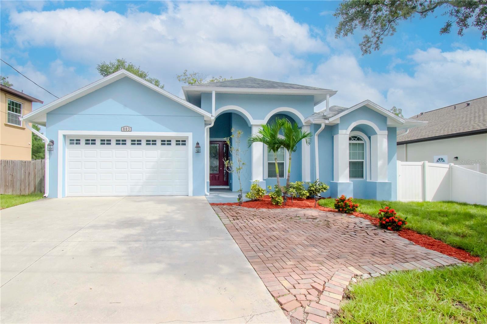 Welcome to Hillsborough River Estates! This newer BLOCK construction, 4 bed/2 bath/2-car garage home offers an open floor plan with high ceilings, custom coffered detail, and wood-look tile throughout. The chef’s kitchen features granite counters, a large island, and stainless steel appliances—perfect for entertaining. Split bedroom layout ensures a private master retreat with tray ceiling, walk-in closet, and spa-like bath with soaking tub, tiled shower, and dual vanities. Enjoy a covered front porch and motorized sunshade over the rear patio. Prime location across from Lowry Park Zoo with direct access to the scenic Lowry Park Trail along the Hillsborough River. Walk to parks and dining in Seminole Heights. No CDD, No HOA, and NOT in a flood zone! Easy commute to Downtown Tampa & MacDill AFB. Your forever home awaits!