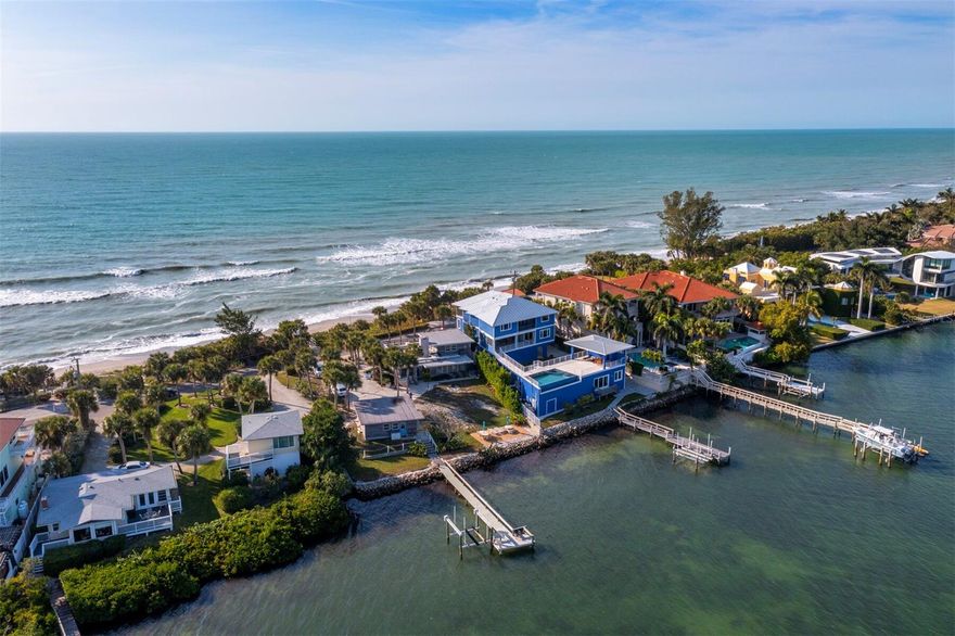 Double Your Pleasure: Two Beaches, One Visionary Opportunity on Casey Key. Why settle for one beach when you can own both? This exceptional Gulf-to-Bay property on exclusive Casey Key offers the rare opportunity to enjoy 89 feet of private beachfront on the Gulf of Mexico and a newly expanded sandy shoreline along Blackburn Bay—an extraordinary transformation brought on by recent storms that created a unique dual-beach experience. Spanning .58 acres, this property is a true canvas for visionary living. Imagine designing a custom architectural masterpiece where every window frames breathtaking sunrises over the bay and glowing sunsets over the Gulf. From boating to beachcombing, the possibilities are endless with your own private dock, Gulf-front beach, and tranquil bay access—ideal for paddleboarding, kayaking, and launching your next waterfront adventure. The existing vintage 1951 beach cottage exudes a nostalgic charm, reminiscent of a bygone era. With pecky cypress siding, a cozy brick fireplace, and an elevated split-level design, it feels like your grandparents’ beach house—warm, quirky, and full of character. Inside, you'll find two bedrooms, two full baths, and a surprise third bathroom cleverly tucked into the laundry room with a shower, toilet, and utility sink for added functionality. A rooftop deck crowns the home, offering panoramic Gulf-to-Bay vistas that must be seen to be believed. Recent upgrades include two new AC units (2024) and a roof replacement (2015). The elevated structure stayed dry during recent storms, and new garage doors offer peace of mind. Whether you're planning to live here while finalizing design plans or simply looking to landbank a premium Gulf-to-Bay lot, the rental income potential is significant. Zoned for single-family use, Casey Key invites you to create something truly extraordinary. This location, near the coveted south bridge, provides easy access to fine dining, boutique shopping, entertainment, and Venice Airport for private travel. Surrounded by multi-million-dollar estates, this is a once-in-a-lifetime opportunity to claim one of the most dynamic waterfront parcels on Florida’s west coast. Schedule your private tour today and envision the future—where your dream home bridges the Gulf and the bay in timeless style.