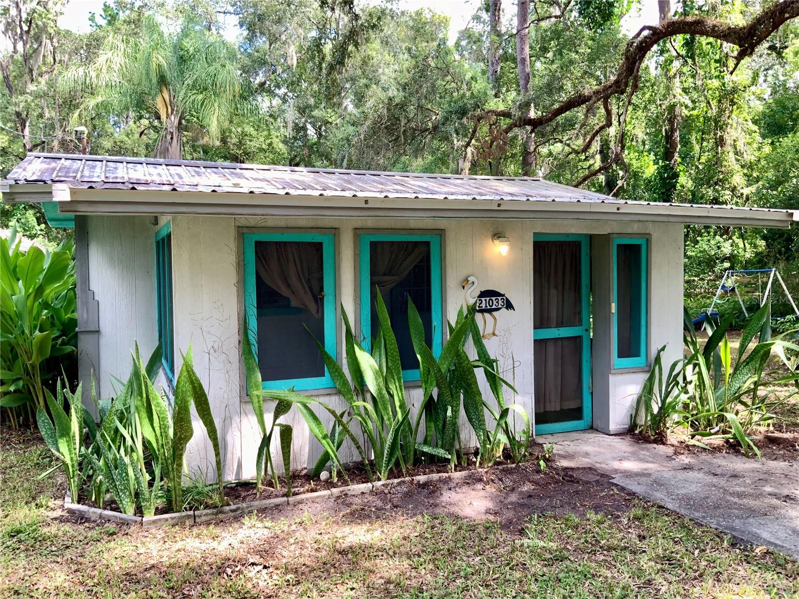 Investor Alert! This unique half-acre corner property offers incredible potential and flexibility. Nestled just minutes from downtown Brooksville, it features a charming 1-bedroom, 1-bathroom cottage complete with a full kitchen and a durable metal roof installed in 2017. Also located on the property is an older mobile home, likely a tear-down, providing an opportunity to start fresh or expand your investment vision.
The property includes two separate addresses, two electric and water meters, a shared septic system, and public water. Whether you choose to live in one unit and rent the other or develop both for dual income streams, the possibilities are wide open. With easy access to State Road 50 and US Hwy 41, plus just a 10-minute drive to the Suncoast Parkway, this location combines small-town charm with big-time convenience.
Don’t miss this prime opportunity with tons of potential!