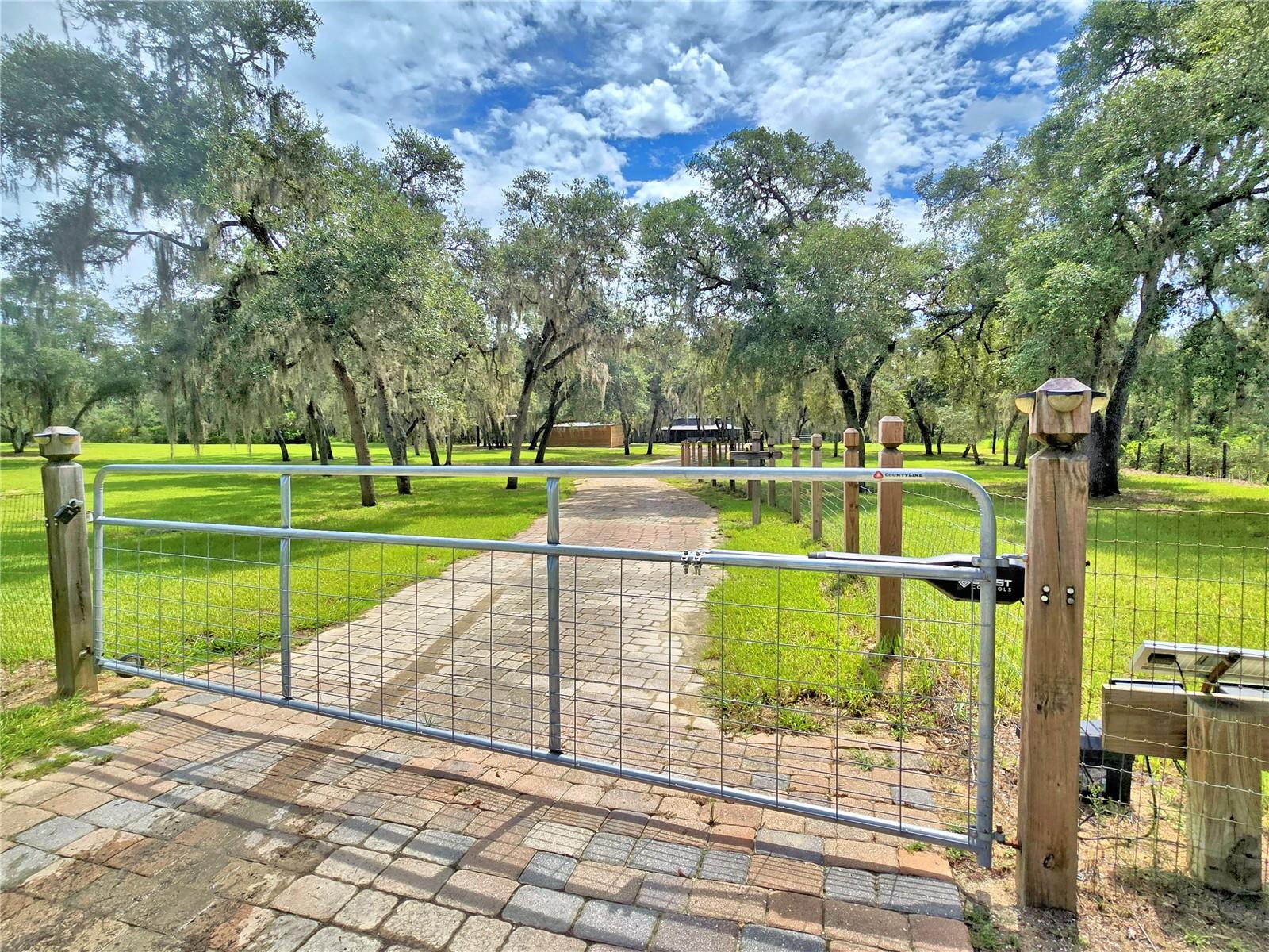 Escape to your private rustic retreat in Tiger Creek Forest! This beautifully remodeled and truly one-of-a-kind 1985 hexagonal wooden log home sits on 5 fully fenced acres in Lake Wales, offering the perfect blend of charm, functionality, and self-sufficiency. From the moment you enter the property on the paver-lined round-about driveway, you’ll appreciate the care and upgrades that make this entire property move-in ready.
Enjoy the Florida lifestyle from the gorgeous wrap-around porch, gather around the fire pit, or entertain under the covered cookout area. Animal lovers and hobby farmers will love the setup—a two-story horse barn with two stalls, chicken coop with atrium, rabbit hutches, and a separate horse paddock already in place. There's also a Smithbilt storage shed, two covered pole barns for vehicles, toys, or equipment, and a 12x16 well house.
Major updates include a new AC and ductwork replaced in March 2025, a new roof installed in April 2025, and a new hot water heater also added in April 2025. The septic tank was pumped in March 2025. Kitchen appliances were updated in 2022, and a Culligan water treatment system was installed in 2018. The property features underground water lines and irrigation zoning around the perimeter—ideal for maintaining pastures or future garden beds.
Whether you're looking for a full-time residence, hobby farm, or unique country getaway, this special log home checks every box.