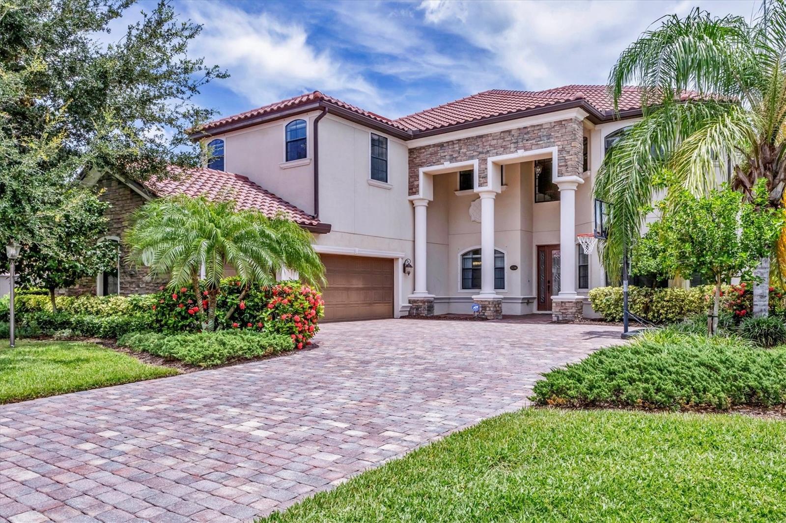 If you are looking for a water view, you won't want to miss this breathtaking estate home with a pool and spa in the exclusive, gated community of Bridgewater, nestled in the heart of Lakewood Ranch. This exceptional residence offers nearly 4,000 square feet of luxury living space with long, serene water views! With 6 spacious bedrooms, 4 bathrooms, a private pool and spa, and an expansive lanai, this home provides an idyllic blend of elegance and functionality for indoor and outdoor living. Upon entering, you’re greeted by a grand two-story foyer leading to a formal living room adorned with bay windows that bathe the space in natural light and staircase that provides access to the second story and kitchen. The formal dining room showcases a stunning chandelier, setting the stage for unforgettable gatherings. The family room features a large sliding glass door offering picturesque pool and water views and high-end drapery. Designed for culinary enthusiasts, the gourmet kitchen is equipped with premium finishes and stainless steel appliances, including a cooktop with a hood, built-in oven and microwave. A breakfast bar that seats four and an additional eat-in area with pool deck access provide multiple dining options. The covered lanai is ideal for alfresco entertaining, offering ample seating and direct access to a poolside bathroom with a walk-in shower. There is plenty of room to install an outdoor kitchen or bar as well! Relax and unwind in the pool or hot tub while enjoying the tranquil water views, or soak up the Florida sunshine on the expansive, screened-in lanai. Upstairs, the luxurious primary suite boasts a screened-in balcony, two walk-in closets, and an elegant en-suite bathroom with dual vanities, a soaking tub, and a large walk-in shower. Three additional bedrooms - two with screened-in balconies - share a bathroom with a double sink vanity, while a versatile oversized bedroom with an en-suite bathroom serves as a potential theater, game room, or in-law suite. The loft is the perfect spot for an office, play room or space to relax after a day in the sun. There is another bedroom on the main level that can be used a guest suite or private home office. Freshly painted on the interior, this home also features an oversized, side-load 3-car garage with ample room for storage, a golf cart, and all your recreational gear! HOA-provided lawn care and irrigation ensure low-maintenance living, giving you more time to enjoy all Lakewood Ranch has to offer. This home sits on one of the best lots in the community - which offers privacy, unbelievable views, space for entertainment and gardening enjoyment. Located in an A-rated school district and close to Lakewood Ranch Prep Academy, this home is just minutes from “The Green,” Lakewood Ranch’s bustling shopping and dining hub. Experience the active Florida lifestyle in the top-ranked Lakewood Ranch community, offering golf courses, downtown amenities, 60+ resident clubs, 150 miles of trails, dog parks, and more. Beautiful Sarasota and Bradenton beaches are just 15 miles away and you'll have easy access to Sarasota and Tampa International Airports. Don’t miss the chance to make this stunning home yours and live the ultimate Florida lifestyle! *BRAND NEW AC SYSTEMS*