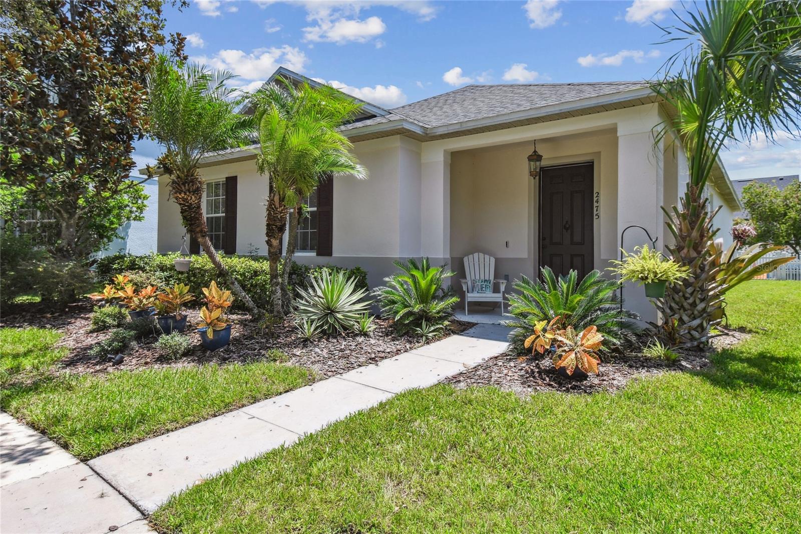 WELCOME HOME - Pulling up to the curb, you're immediately greeted by the charm of a welcoming front porch—an ideal spot to sip a cold lemonade while enjoying peaceful views of shade trees and the lush greenbelt beyond. This picture-perfect moment sets the tone for everything this thoughtfully designed Avalon Park home in the heart of East Orlando has to offer. Step inside to discover a light-filled open-concept layout where both formal and informal living spaces flow seamlessly together—perfect for entertaining, relaxing, or spending time with loved ones. Cool-toned, WOOD-LOOK TILE FLOORING runs throughout the home, offering both warmth and durability with easy maintenance. At the center of it all, the kitchen shines as the heart of the home. It boasts 42" white-painted cabinets with elegant crown molding, gleaming QUARTZ COUNTERTOPS, and a beautifully detailed mosaic tile backsplash. The culinary enthusiast will appreciate the large central island with breakfast bar seating, sparkling stainless steel appliances, and a walk-in pantry make the space as functional as it is stylish. Most of the lower cabinets feature convenient pull-out shelves, keeping your essentials neatly organized and within reach—all beautifully illuminated by a designer pendant light. Nearby, an INDOOR LAUNDRY ROOM adds convenience to daily living and is just adjacent to the two-car, rear-entry garage. The owner’s suite is a perfect place to unwind with a spacious walk-in closet and a spa-inspired ensuite bath featuring dual-sinks, a garden soaking tub, and a glass-enclosed shower. Two additional bedrooms share an updated full bathroom, ideal for guests or housemates. Step through sliding glass doors—framed by classic plantation shutters—into your white PICKET-FENCED BACKYARD, a serene outdoor haven ideal for gardening, grilling, or simply soaking up the Florida sunshine. Beyond the home itself, Avalon Park offers resort-style amenities including a sparkling community pool, tennis, basketball and racquetball courts, dog park, playgrounds, scenic walking trails, and a full calendar of community events. Top-rated schools, dining, shopping, and entertainment are all just minutes away. This home blends timeless curb appeal and southern charm with modern comfort in one of East Orlando’s most sought-after neighborhoods. COME EXPERIENCE IT FOR YOURSELF!