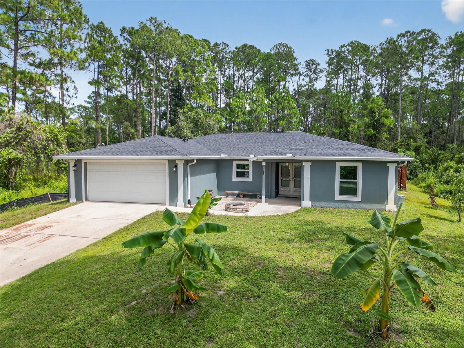 Welcome to your move-in ready oasis at 1385 11th Avenue, DeLand, FL 32724 - a beautifully remodeled, concrete-block, 4-bedroom, 2-bathroom split-plan home in the heart of Daytona Park Estates combining privacy, modern comfort, and smart value.
Step inside to discover 1,710 sq ft of open living space with recent upgrades throughout: fresh interior & exterior paint, LVP & ceramic tile flooring in main areas, lush carpet in bedrooms, upgraded lighting with ceiling fans. The kitchen dazzles with granite countertops, stainless steel appliances, a huge walk-in pantry, and white cabinetry offering both style and function. The master suite is roomy and serene; the bathrooms have been thoughtfully updated.
Impact-rated Windows installed 2023, Roof and Gutters replaced in 2022, HVAC system just 5 years old, stabilizing piers professionally installed in 2022 for long-term structural confidence, Generator Hookup, Whole-house Water Filtration and Softener + Reverse Osmosis System under kitchen sink – making this home low maintenance and worry-free.
Outdoors is your own resort-style retreat: a pool (installed 2023) heated via solar tubing; a lush, private backyard on over a quarter acre lot; raised garden beds; fruit trees including banana, lemon, lime, and moringa. Perfect for entertaining or peaceful relaxation.
Bonus: this home sits elevated despite being in Flood Zone A; no known history of water intrusion even in recent storms/hurricanes. Behind the privacy fence is a drainage canal. Access is via paved roads almost all the way; the final stretch is a county-maintained private dirt road that adds charm and seclusion without sacrificing convenience.
Financing perk: assumable loan at just 4.13% (about $44K gap required) for qualifying buyers—an opportunity in today’s rate environment. Whether paying cash or financing, this home represents exceptional value.
Location offers peace and privacy, yet you're only minutes from shopping, schools, dining, and DeLand’s charming downtown. 20 miles to Daytona Beach. 5 miles to I-4/SR 44 interchange for easy commute to Orlando. HVAC, roof, pool, kitchen—all ready for your enjoyment from day one.
Don’t miss this one… move in before the holidays!