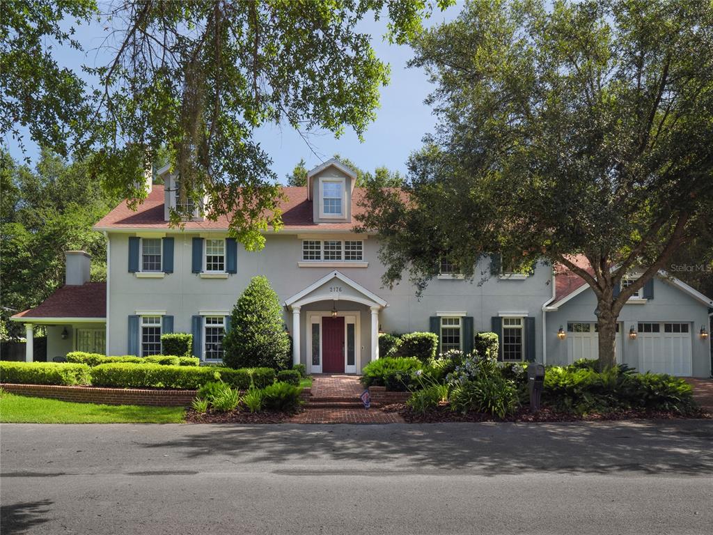Your AMAZING GEM in the very heart of Gainesville ~ Two blocks from the renowned University of Florida! This spectacularly impressive home offers majestic curb appeal, incredible quality, craftsmanship, and artistry. The dramatic 27ft foyer welcomes you in and the ambiance of this treasure will carry you throughout. Stylish and abundant moldings accentuate the attention to detail that is evident at every turn. Warm, rich in character, and plentiful in gathering and relaxation spaces. The kitchen will delight the most discerning chef-de-cuisine of the house as it's outfitted as one would expect with a massive center island, 6 burner Wolf gas range, double ovens, Wolf microwave, Bosch dishwasher, gorgeous solid surface counters, custom features and fixtures and is complemented by an adjacent Butler's Pantry. This home was designed with elegance, private personal enjoyment, entertaining and stylish luxury as its guide. Exquisitely furnished, enhancing the allure of your very own retreat, so just bring your suitcases and enjoy! Spacious rooms, a huge balcony and covered screened porch, 4 en-suite bedrooms plus a half bath, a Charming library/study/den in addition to the grand living/family room, elegant dining room, entertaining bar, and gym/flex/office/bonus rooms. The garage has split garage doors and a Telsa charging station. Tastefully landscaped fenced yard - Superior UF location, just steps to the many, many campus activities and events and with easy/fast access to UF Health/Shands, The VA, North Fla Hosp, and the wonderful outdoor activities, restaurants, and shopping options that make Gainesville an incredible place to Live-Work & Play !!!
