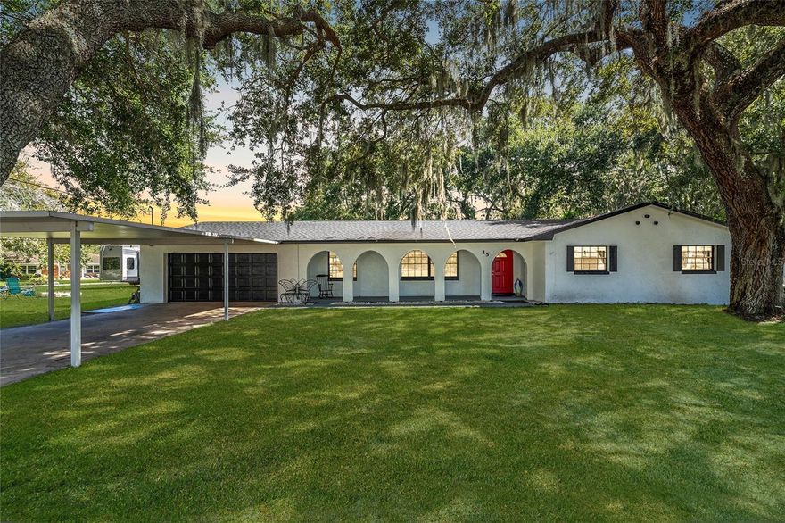 This beautifully updated home with a newer roof for peace of mind rests on a .76-acre oak-shaded corner lot in a quiet, established neighborhood. Located within easy walking distance to downtown Kissimmee, Neocity, and the SunRail station, it offers both serenity and accessibility. NO HOA here, and you’ll also enjoy effortless access to restaurants, shopping, public boat ramps, and the nearby bass-rich waters of Lake Toho. Inside, large windows fill the space with natural light, complementing a neutral color palette, updated lighting fixtures, and newly installed luxury vinyl plank flooring. The open living area is perfect for entertaining, featuring wide open spaces and a stacked stone fireplace that sets the tone for gatherings. Glass-inset French doors lead to a spacious screened Florida room with an in-ground spa, ideal for relaxing while overlooking the peaceful, tree-lined backyard. The recently updated kitchen is thoughtfully designed with Shaker-style cabinetry, a stainless farmhouse apron sink, recessed LED lighting, solid surface countertops, stainless steel appliances, and a center island that invites casual dining and conversation. The owner’s suite offers a spa-inspired retreat with a marble-topped double vanity and a walk-in shower adorned with custom tilework and pebble-style flooring. Two additional guest rooms and an updated full guest bath provide comfort for visitors or a growing household. A dedicated laundry room with a front-load washer and dryer adds everyday convenience. Bring your toys as the oversized lot easily accommodates boats, RVs, and outdoor gear. A storage shed adds functionality, and mature landscaping enhances the sense of calm and privacy. This home delivers the peaceful feel of country living with all the conveniences of city life, making it a rare and inviting find in the heart of Kissimmee.
