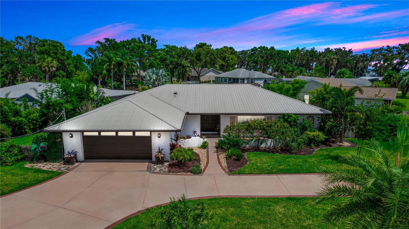 Your Dream Waterfront Escape Awaits! Picture this: You wake up to the soothing sounds of nature, step onto your private lanai with a steaming cup of coffee, and gaze out at the calming canal that leads you directly to beautiful Lake Eustis, part of the Chain of Lakes. This stunning, updated 3-bedroom, 2.5-bathroom split-plan home is more than just a house, it’s your ticket to an unbeatable Florida lifestyle, where relaxation and adventure collide! Forget HOA hassles—here, you're in charge, free to make this waterfront paradise truly your own. Boating enthusiasts will love the fully functional boat lift, covered dock with a concrete seawall, and easy access to endless water adventures including fantastic Bass fishing! Not in the mood for boating? Cool off in the sparkling pool, host an unforgettable gathering in your outdoor kitchen space, or just soak up the sun with a good book—this home was made for living your best life! Inside, the spacious open-concept design is perfect for entertaining, with two primary suites, each featuring ensuite bathrooms and walk-in closets—because luxury should come standard. Thoughtful updates throughout ensure effortless comfort, including dual HVAC systems, a newly upgraded 300 Amp circuit panel with a 220V RV hookup, and premium scratch-resistant flooring that’s stylish and durable. More upgrades such as double-paned, gas-insulated vinyl windows, metal roof, and expanded sliding patio doors, seamlessly connecting indoor and outdoor living. Step outside to lush live oaks, maple trees, and majestic palms, all beautifully complementing the stained and sealed circular driveway. You’re just minutes from the charming towns of Mt. Dora, Tavares, and Leesburg, so whether it’s shopping, dining, boating, or biking, there’s always something to explore. This is truly a rare opportunity for you to snag this meticulously upgraded waterfront retreat, whether it is a boat day, or float in the pool with a drink day, here is your chance to live it—every single day! If you’re ready to trade ordinary living for extraordinary experiences, this piece of paradise is calling your name—don’t let it slip away!
