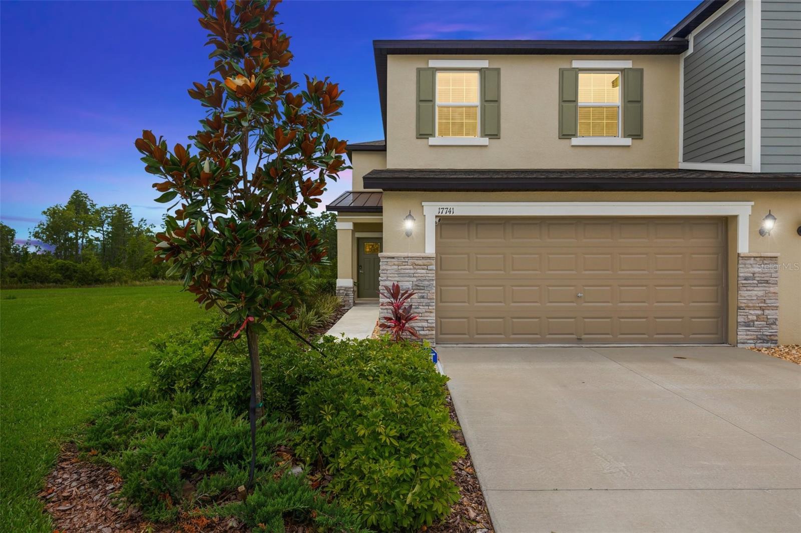 Modern Elegance with Water & Conservation Views in Angeline. This beautifully upgraded two-story townhome offers the perfect blend of style, comfort, and location. Situated on a quiet cul-de-sac street, this home boasts serene water and conservation views with a large open green space right next door providing extra privacy and room to roam. Inside, the open-concept layout seamlessly connects the kitchen, dining area, and family room, flowing onto a covered lanai equipped with sun shades and a designer ceiling fan ideal for enjoying Florida living at its finest. The modern kitchen features stainless steel appliances, quartz countertops throughout, pendant lighting, and sleek finishes. Ceiling fans in every room and an included washer and dryer add everyday comfort and convenience. Upstairs, the spacious owner’s suite is privately positioned at the front of the home with a full en-suite bath, while two secondary bedrooms are located at the rear for added separation and quiet. Located in Angeline, a 6,200+ acre master-planned community in Land O’ Lakes, this home is part of a vibrant lifestyle destination featuring 3,600 acres of green space, up to 100 miles of trails, a community farm, Wild Thyme Cafe & Market, future Lagoon, Pasco County park, STEM Magnet School-Angeline Academy of Innovation, Angeline County Day Pk2-5 grade private school, and the forthcoming Moffitt Cancer Center, Speros FL campus. Make your appointment today to view the beautiful property before it's gone!