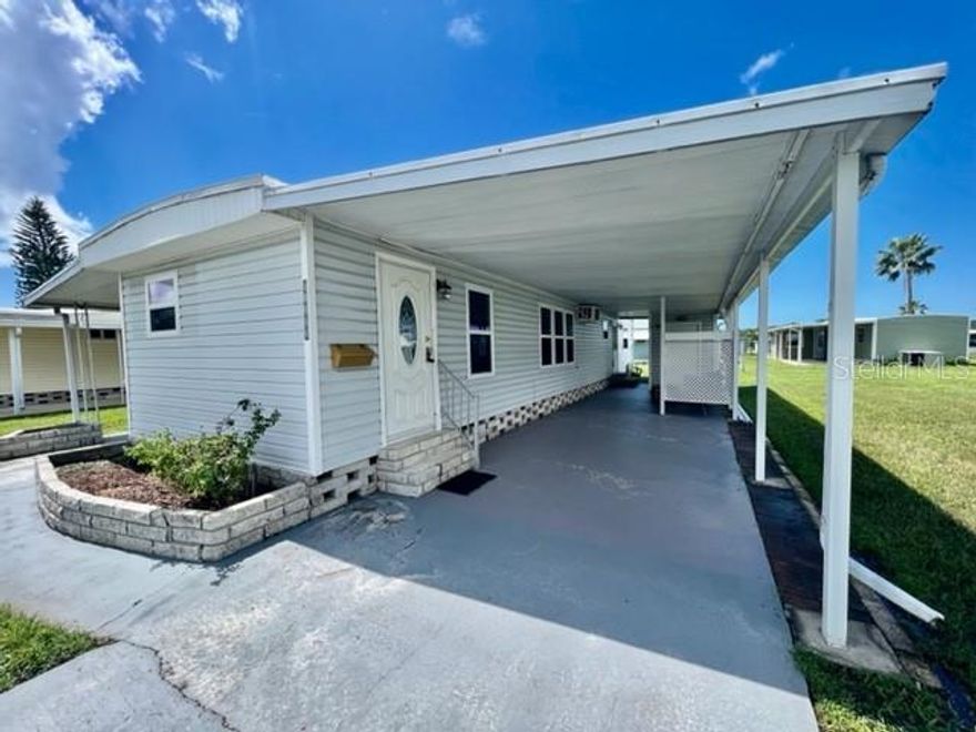 WELCOME TO YOUR HOME SWEET HOME at 10819 London Dr, Port Richey in the gated community of Senate Manor, a 55+ cooperative community in SUNNY Florida. This 1972 SUPERB 2 bedrooms + large FL room, 1 bathroom mobile home lies on a nice lot with just under 5,000 sqft in a NO CDD zone. Key exterior features are covered front porch where you can meet & greet your neighbors, 3 entrances into the home, rain gutters, updated windows with shade shutters for storm protection, carriage lights & easy-breezy TROPICAL landscaping that is taken care of for you. AMAZING features are NEWER ROOF (installed 8/2024), updated electrical panel (2001 permit), oversized carport for your vehicle & golf cart & stone skirting around the perimeter to prevent unwanted critters. When you step inside, you'll LOVE the OPEN FLOOR PLAN consisting of the eat-in-kitchen, living & dining rooms & SPACIOUS lanai/Florida room. Add a portable AC unit or mini-split & this LOVELY Florida room can easily increase the square footage by 160 sqft. The WONDERFUL eat-in kitchen features a double stainless steel sink with gooseneck faucet with window view, pantry closet, plentiful cabinets with hardware, CUTE corner nook with extra cabinets for storage, expansive counters & NICE backsplash in WARM TONES. The living room has raised ceilings, PRETTY laminate wall in a herringbone pattern, fan & floors dressed in durable laminate for easy breezy maintenance. The primary bedroom can fit queen furniture, has dual closets & a built-in study area. The second bedroom with closet & built-in desk is a PERFECT guest spot or transform it into your office/craft room or personal library. The generous-sized, updated bathroom features sink, vanity, newer toilet, lots of counter space, wall sconces, bead board feature wall, framed mirror & step-in shower with shelves. The 2-in-1 washer & dryer machine is also located in the bathroom & INCLUDED in the sale. AWESOME IMPROVEMENTS include: Replacement of 12 windows & 3 doors with permits 5/2024, 3 NEW MINI-SPLIT AC/HEAT SYSTEMS (both bedrooms & living room), plywood subfloors & new flooring & new baseboards. Storm surge water did not enter the main living part of the home but the community of Senate Manor did experience storm surge from Helene. The CONVENIENT storage shed with additional laundry hookups is great for your garden tools or beach gear. Senate Manor is a GLORIOUS RESIDENT-OWNED 55+ COMMUNITY & included in the low HOA fee of $200/month is trash with recycling pick-up 2X week, all exterior lawn maintenance, water, sewer, street lights, water with fountain views, gates & recreational activities like HEATED POOL & SPA, shuffleboard, horseshoes & gym. There is optional storage for boats, RVs or trailers on site. Location is IDEAL near beaches, shopping, restaurants, medical plazas, places of worship & tourist attractions. This STELLAR, move-in ready home is sold FURNISHED for immediate enjoyment for the lucky new buyers! MAKE THIS YOUR FUTURE HOME!