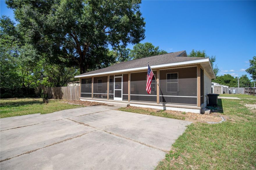 ** PRICE IMPROVED!!!** Welcome HOME!!! 3 bedroom, 2 bath home in the thriving town of Oxford! With its enclosed front and back porches, you'll have plenty of space to relax and soak up the Florida sunshine in style. Oversized detached garage - perfect for storing your vehicles, tools, or whatever else you need! (Main garage 35’X33’ and open garage on right side 14’x23’) 
The real magic of this property lies in its location - just minutes away from the bustling hub of The Villages, the FL Turnpike, and the rapidly expanding areas around it. Rural residential zoning that allows you to bring your animals!! 
Kitchen appliances, water heater, and air conditioner unit installed in 2021. With exterior security lights on both of the house and barn out back, you can rest easy knowing that your home is safe and secure. Speaking of the backyard, you'll love the convenience of the second well and 30amp RV hookup located near the back, making it the perfect spot for weekend getaways or hosting guests. Plus, with both front and back porches now screened in as of 2021, you can enjoy the beauty of the outdoors without having to worry about pesky bugs. The washer and dryer are also included, making this home truly move-in ready. So what are you waiting for? Come experience the best in Florida living today!
