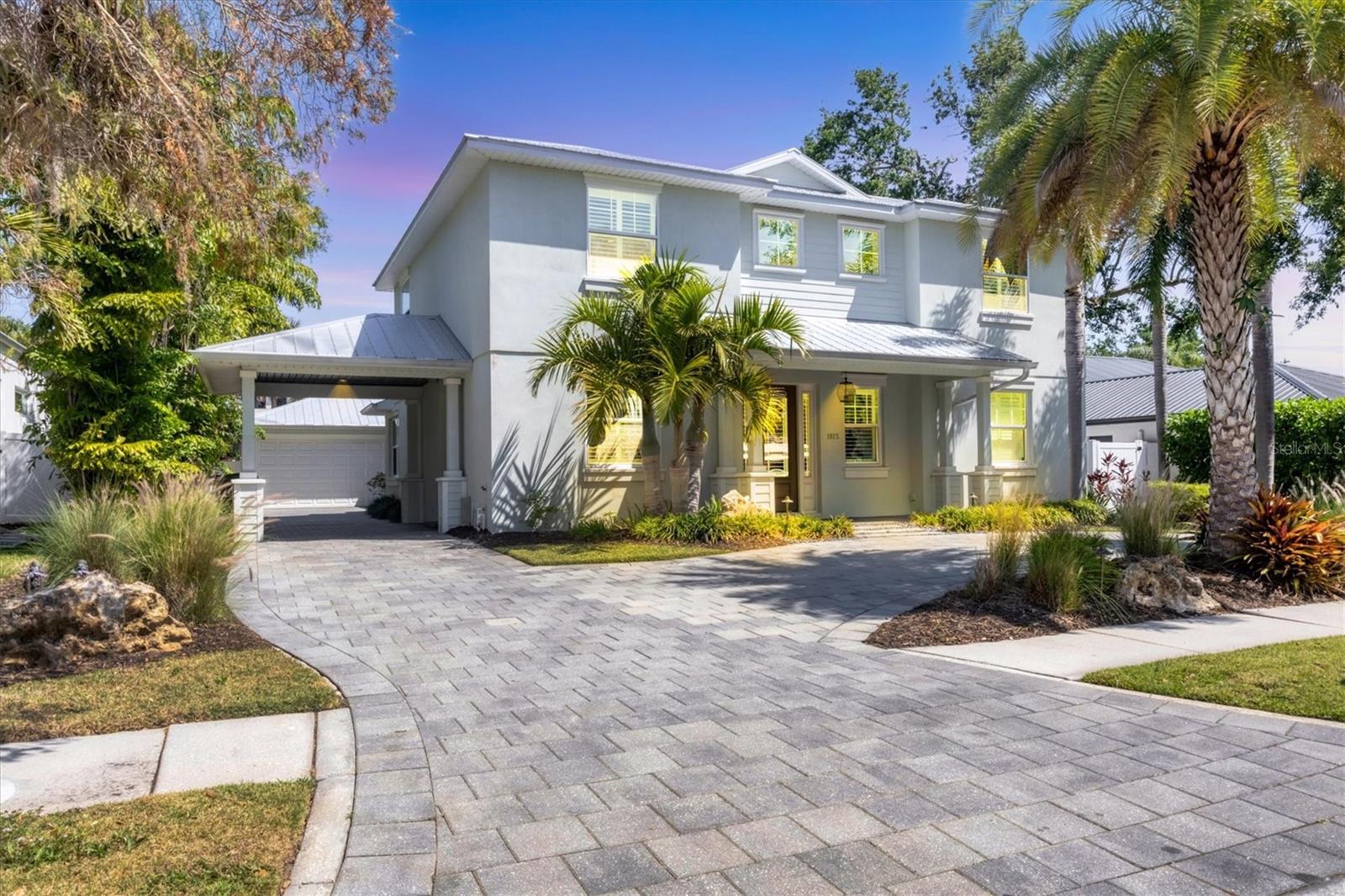Welcome to this beautifully designed pool home in the West of the Trail Sarasota neighborhood. This four-bedroom, three full and two-half-bath residence offers 2,617 square feet under air, 4,188 total, and blends modern style and comfort, with an unbeatable location. Built in 2013, this move-in-ready home features soaring ceilings, crown molding, engineered hardwood floors throughout, impact-resistant windows and doors for your peace of mind, and a spacious open-concept layout. The chef’s kitchen offers stainless steel appliances with a newer refrigerator, an induction cooktop, breakfast bar and flows seamlessly into the living and dining spaces. The first-floor primary suite offers privacy and luxury with access to the backyard oasis, dual walk-in closets featuring custom closet systems, a soaking tub and a large walk-in shower. Upon entering the home you will note there is an office/den right off the impressive foyer. Upstairs, you'll find three additional bedrooms, including a Jack and Jill suite and a private guest bedroom and another full bath for guests or multigenerational living. The incredibly designed backyard is a private, screened-in oasis designed for Florida living. Enjoy a saltwater heated pool, expansive covered lanai, and a separate cabana with a large seating area, mounted TV and outdoor kitchen. Behind the cabana, unwind by the fire pit under hanging string lights for a late-night refresher. A ground-level trampoline and dedicated play area make this a dream for families and entertainers alike. The Mosquito Nix system using natural chrysanthemum ensures year-round comfort at this dreamy backyard. Out front, the home greets you with a gracious circular driveway and a porte-cochere that leads to an oversized detached two-car garage complete with a mini split air-conditioning system and its refrigerator, making it ideal for a gym, hobby space or additional storage. Lush, tropical landscaping is maintained year-round by a dedicated well and irrigation system. All this, just steps from top-rated Southside Elementary, and minutes from Southside Village known for its boutique shopping, fine and casual dining along with its specialty grocery store. Sarasota Memorial Hospital is close along with a short drive to downtown Sarasota, and the award-winning Siesta Key Beach. A rare opportunity to own an exceptional home with exceptional outdoor Florida living in one of Sarasota’s desirable neighborhoods.