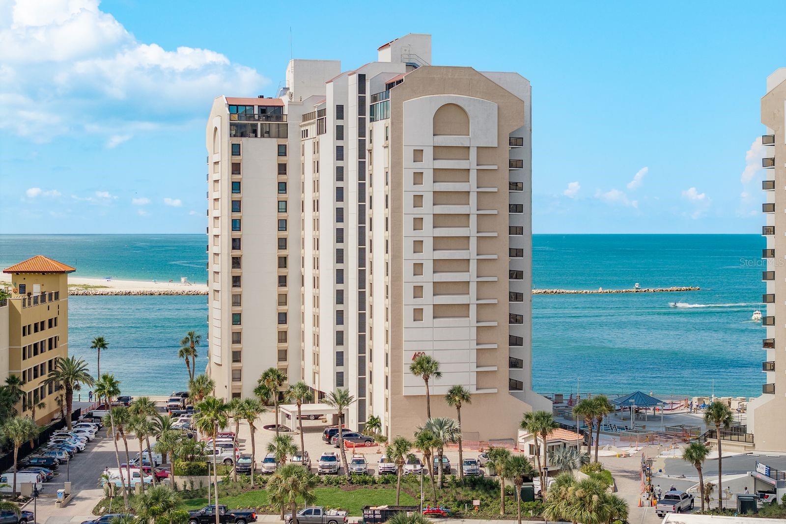 Welcome to resort-style living at 440 West in Clearwater Beach! This fully furnished 2-bedroom, 2-bathroom condo sits on the 9th floor of a 24-hour guard-gated community, with new windows installed in 2024 and a new slider door scheduled for installation through the association. Enjoy breathtaking direct Gulf views and picture-perfect sunsets from your private balcony. Inside, you’ll love the split floor plan with wood-look vinyl flooring in the living areas and bedrooms. The kitchen boasts stainless steel appliances, quartz countertops, and abundant cabinetry, opening seamlessly to the dining and living room combo - perfect for entertaining with a view. A washer and dryer are included for convenience, and the unit comes with an assigned underground parking spot. 450 West is loaded with amenities to make every day feel like a vacation: a heated beachfront pool, BBQ grills, billiards & social room, shuffleboard, fitness room, and sauna. Step outside and you’re just moments from the sugar-white sands of Clearwater Beach, local shops, restaurants, and endless water activities, including fishing charters, dolphin tours, and the Clearwater Marine Aquarium. This condo also offers investment potential with a 30-day minimum lease option. Centrally located near golf courses and Tampa Bay’s vibrant sports scene - Rays baseball, Buccaneers football, Lightning hockey, and spring training facilities. Plus, you’re only 30 minutes to Tampa International and St. Pete-Clearwater airports, and less than an hour to Busch Gardens and Adventure Island. Whether you’re seeking a vacation retreat, full-time residence, or rental opportunity, this turnkey Gulf-front condo checks all the boxes!