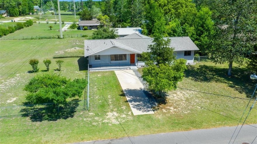 Don’t miss this 3-bedroom, 2-bath home on nearly an acre! Beautiful wood flooring runs throughout, creating a warm and inviting feel. The kitchen features stainless steel appliances with a gas range, adding a modern touch to the home. An enclosed back patio provides additional living space perfect for entertaining or relaxing year-round. Enjoy added flexibility with a unique detached garage/shed, ideal for a dream workshop, hobbies, or extra storage. This property presents an amazing opportunity for buyers looking for a little more land, no HOA restrictions, and the freedom to truly make it their own.