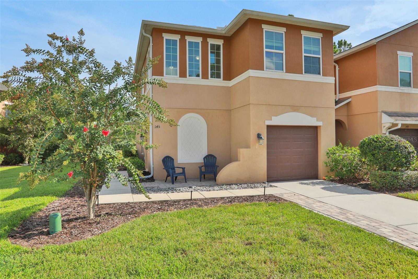 COMPLETELY RENOVATED END UNIT townhouse located in Daytona Beach, just twenty minutes away from the beautiful, iconic beaches of Florida. Throughout the entire home, the floors have been upgraded with sturdy, bright porcelain tile. The kitchen is fully remodeled with modern gray cabinetry, granite countertops, and includes stainless steel appliances as well. The curved staircase has been transformed with authentic oak steps to add to its beauty. On the top floor, a loft area exists, which is flooded with natural light from the many windows that exist in this lovely space. For added convenience, the laundry room can also be found here, with a brand new washer and dryer. The bathrooms all contain modernized showers with gray porcelain tile floors, and subway tiles line the walls. Brand new vanities exist in each bathroom as well, which include granite countertops. To add additional space to enjoy the outdoors, the lanai has now become a screened-in porch with an additional cobblestone patio in the yard to extend outdoor living. A new roof completes this renovation, upgrading the home from builder-grade materials to high-end finishes throughout this lovely home.
