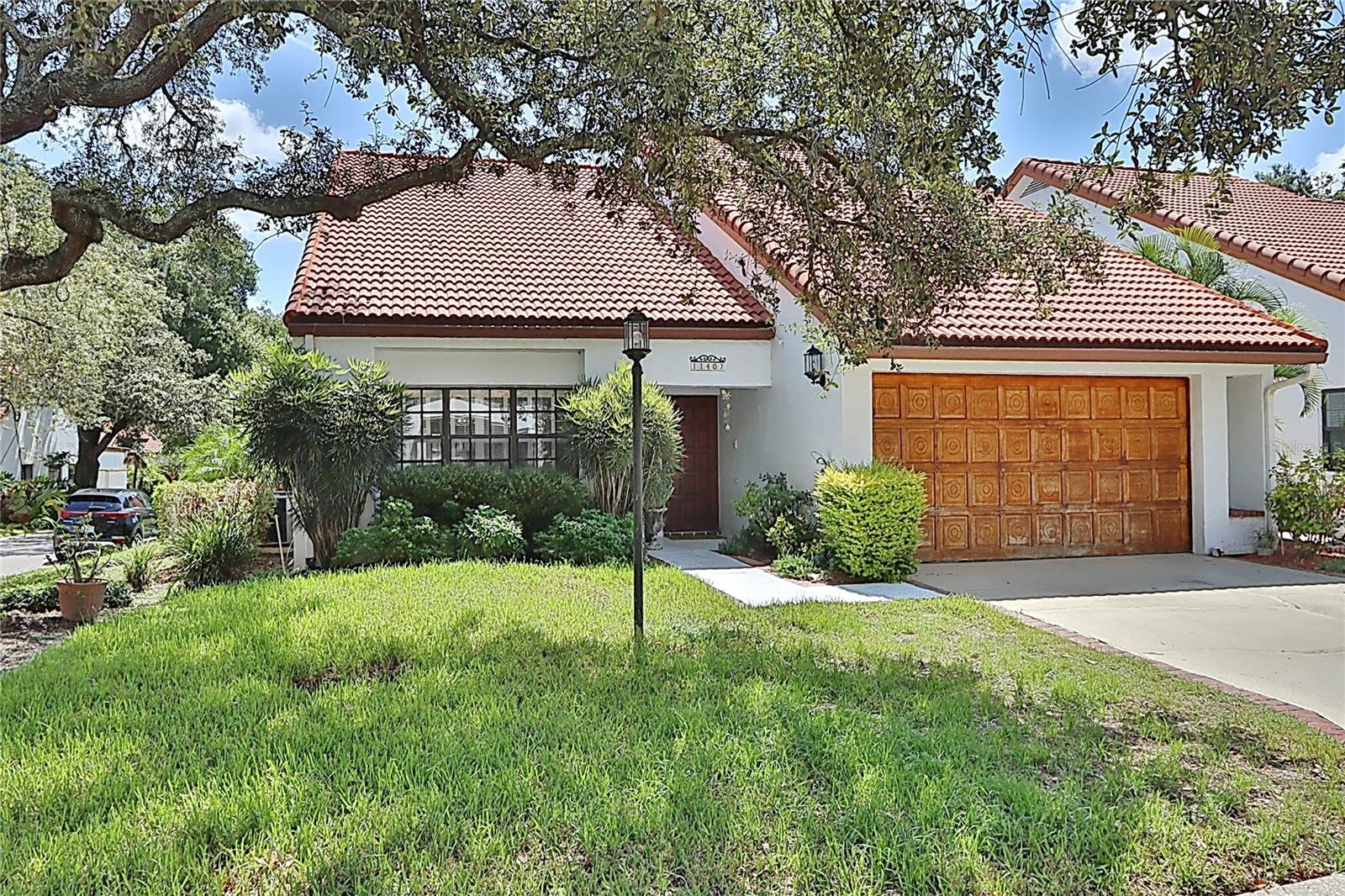 Rare opportunity to own this beautiful home in River Landing - Updated with soaring ceilings and tons of natural light . The master & 2nd bedrooms ( which can also be used as an office) are downstairs. The master has french doors leading to the pool and the second bedroom / office has a beautiful courtyard view. There are 2 bedrooms and full bath upstairs. The master bath features dual sinks, & walk in closet with toilet & shower separate. The family room with vaulted ceilings features a gas or wood burning fireplace with french doors opening to the lanai and pool area. The kitchen has granite countertops, custom cabinetry and a dinette area with beautiful views . Hardwood flooring in the living and dining room . This home is perfect for entertaining and sits on a large corner lot. HVAC 4 years old , water heater 2 years old, Roof 10 years old. The community offers a pool , spa, tennis courts, gazebo & dock overlooking the Hillsborough River. There is a seven acre gated park that is situated along the Hillsborough River. Nestled within the mature oaks and beautiful setting of Temple Terrace Florida , which is one of the last communities that allow residents to drive their golf carts on the street. This community offers golf cart storage for its residents.Close to USF, Moffit, VA , Shopping , restaurants and more . Call today for your private showing !