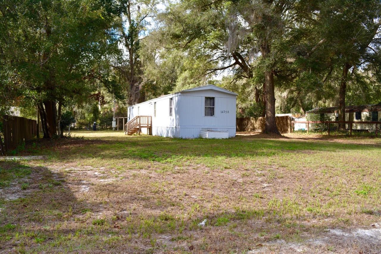 Updated 3/2 1993 mobile home with newer appliances, new AC, and water softener. The 2nd bathroom and one of the bedrooms have new flooring. The back door has been replaced, metal siding & metal roof. No HOA. Great location; private but near to shopping and dining. The couch, TV, and desk that TV sits on do convey. INFORMATION IS DEEMED RELIABLE BUT NOT GUARANTEED…TO BE VERIFIED BY THE BUYER AND/OR BUYER'S AGENT.
